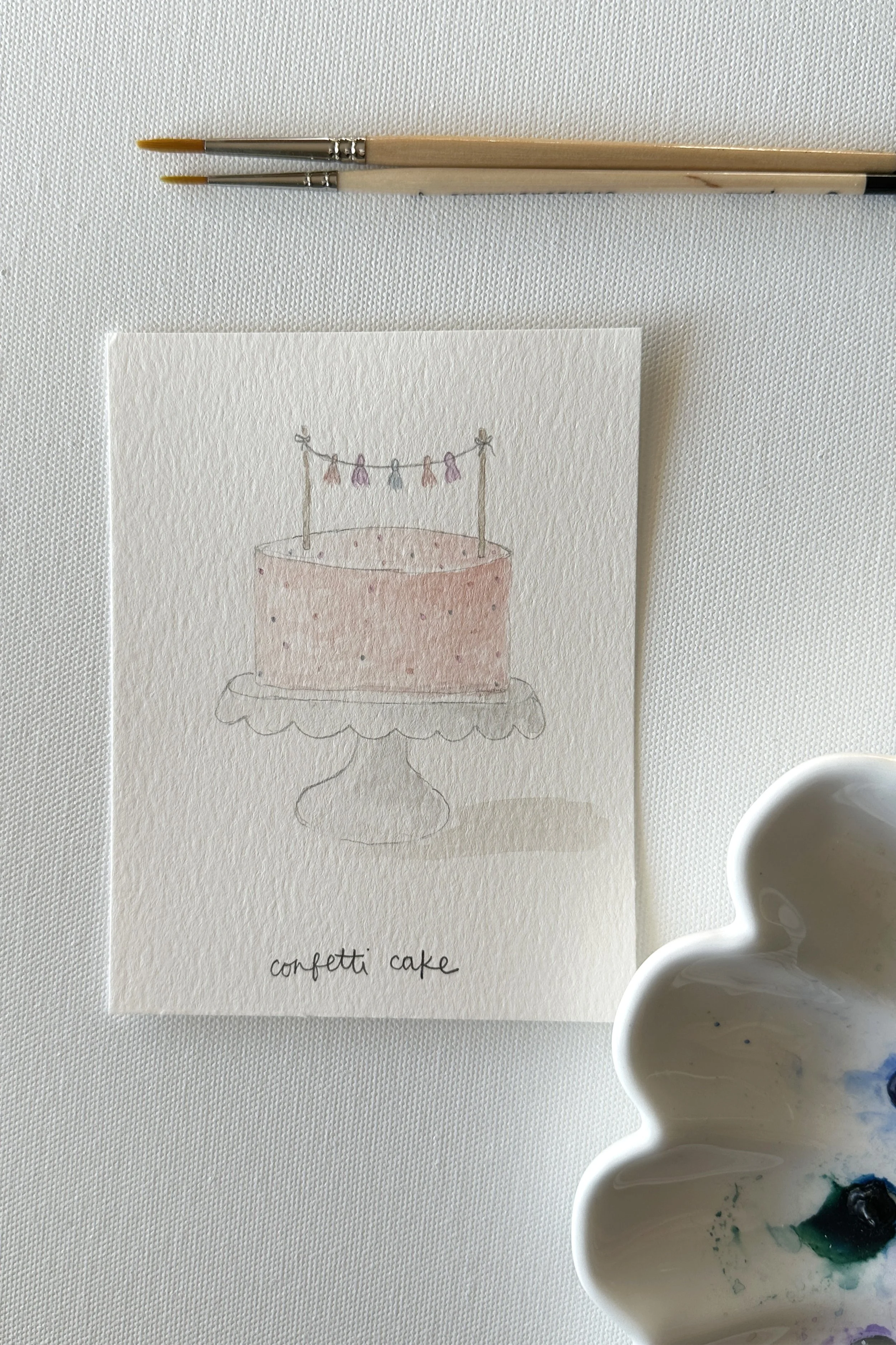 A watercolor birthday cake painted for the June birthday theme.