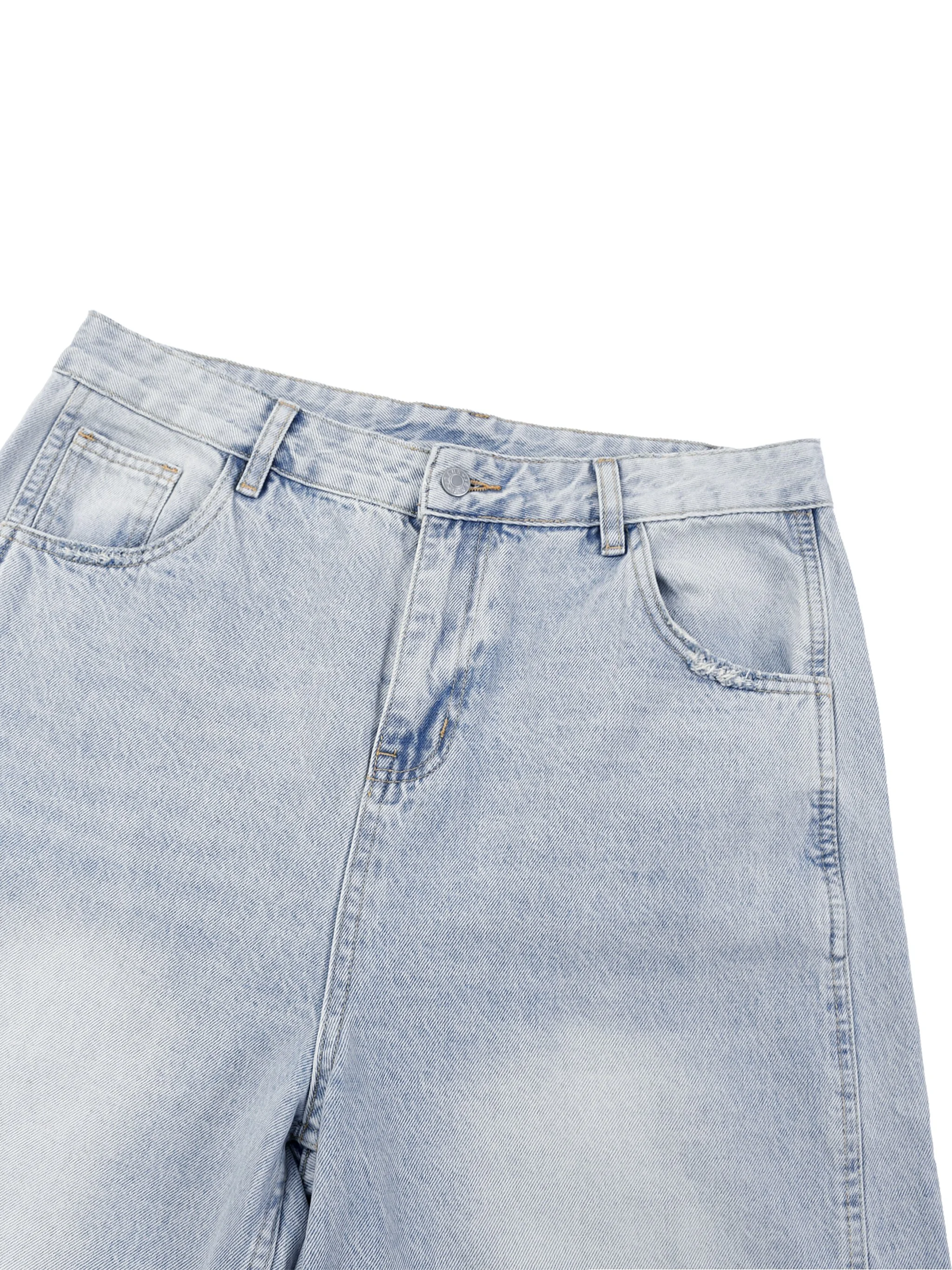 Close-up of back pocket detail on vintage wash barrel leg jeans - sunfade light blue denim texture