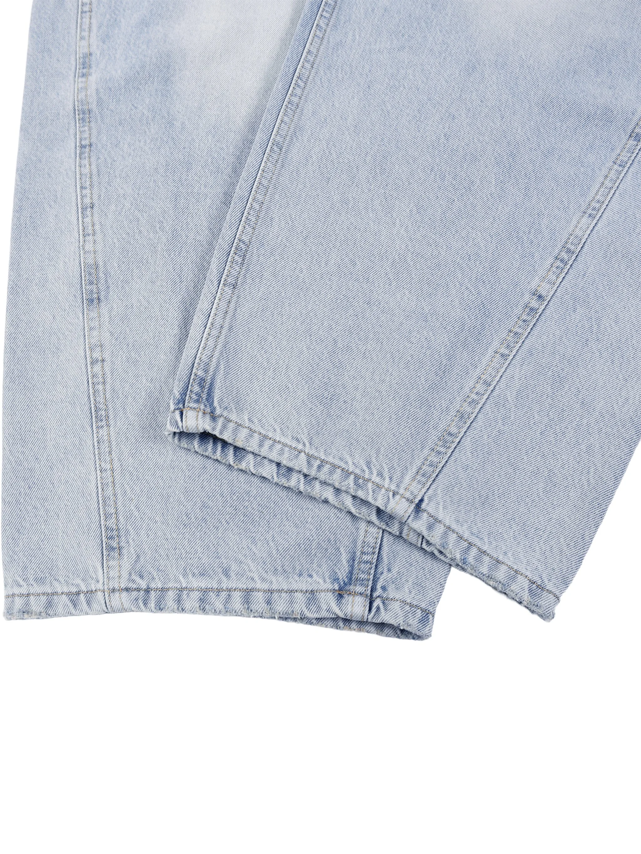 Sunfade barrel leg jeans laid flat showing hem and leg opening - light blue vintage denim