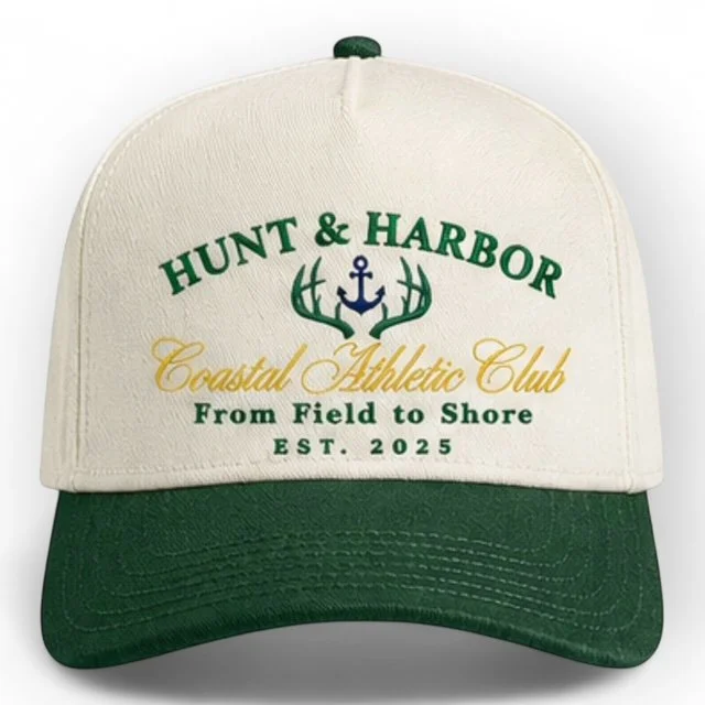 Coastal Athletic Club embroidered cap in Natural and Forest green - two-tone trucker snapback hat with navy anchor logo, front view