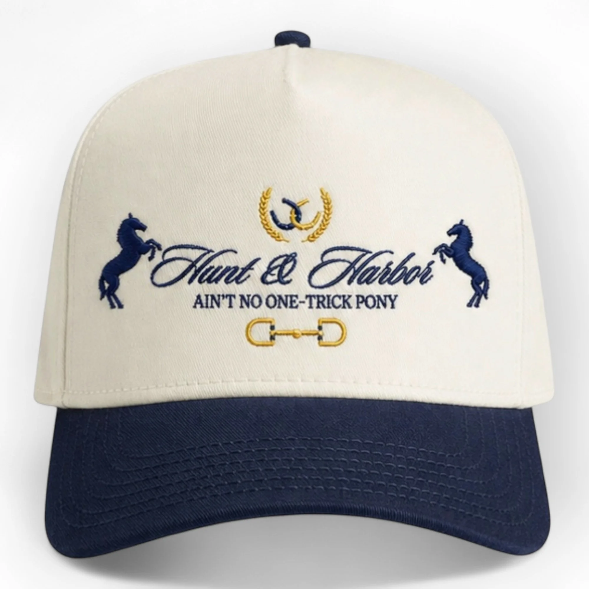 One-Trick Pony embroidered cap in Natural and Midnight navy - two-tone vintage trucker snapback with structured high crown, front view
