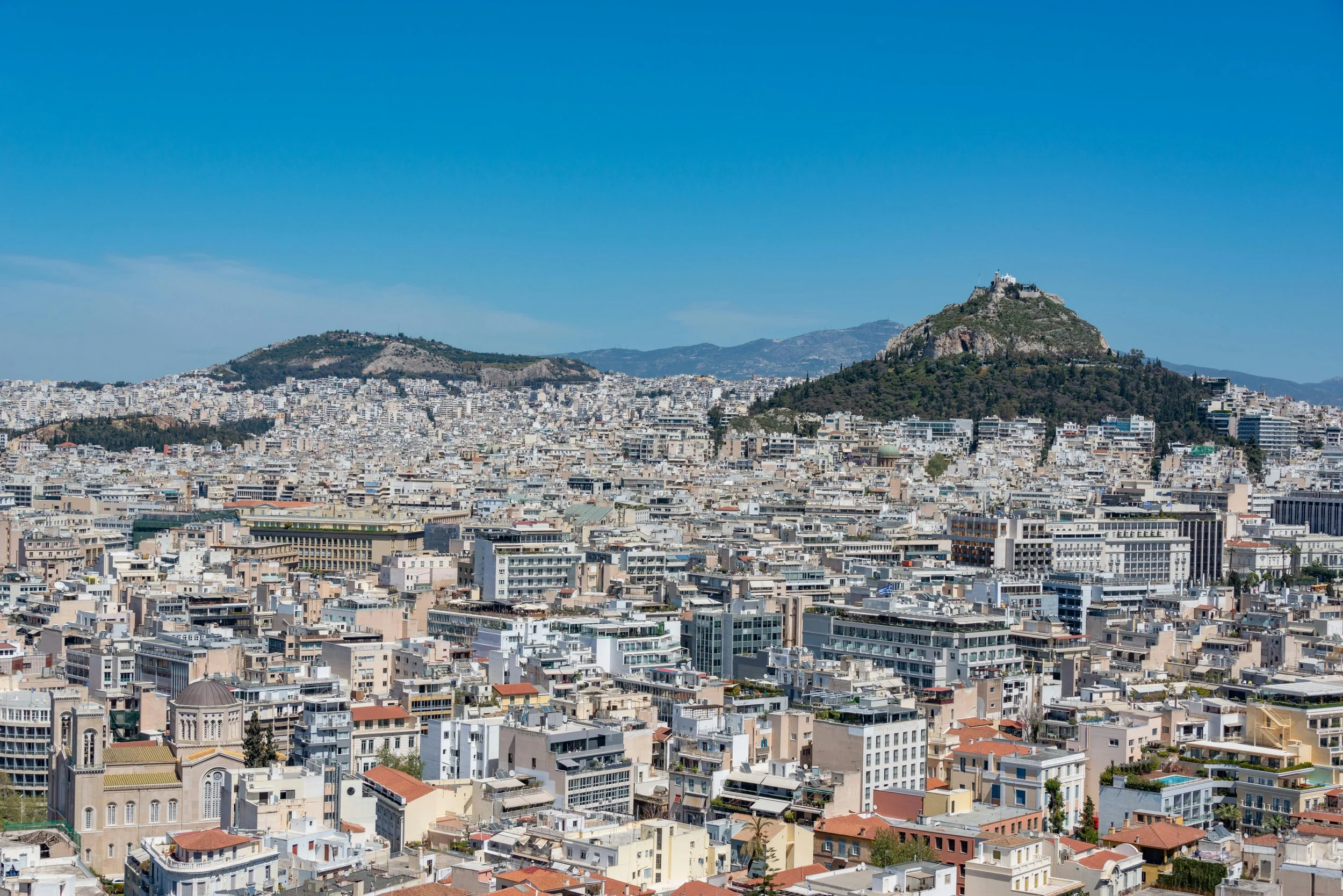 A daytime photograph of the city of Athens - a general city view.