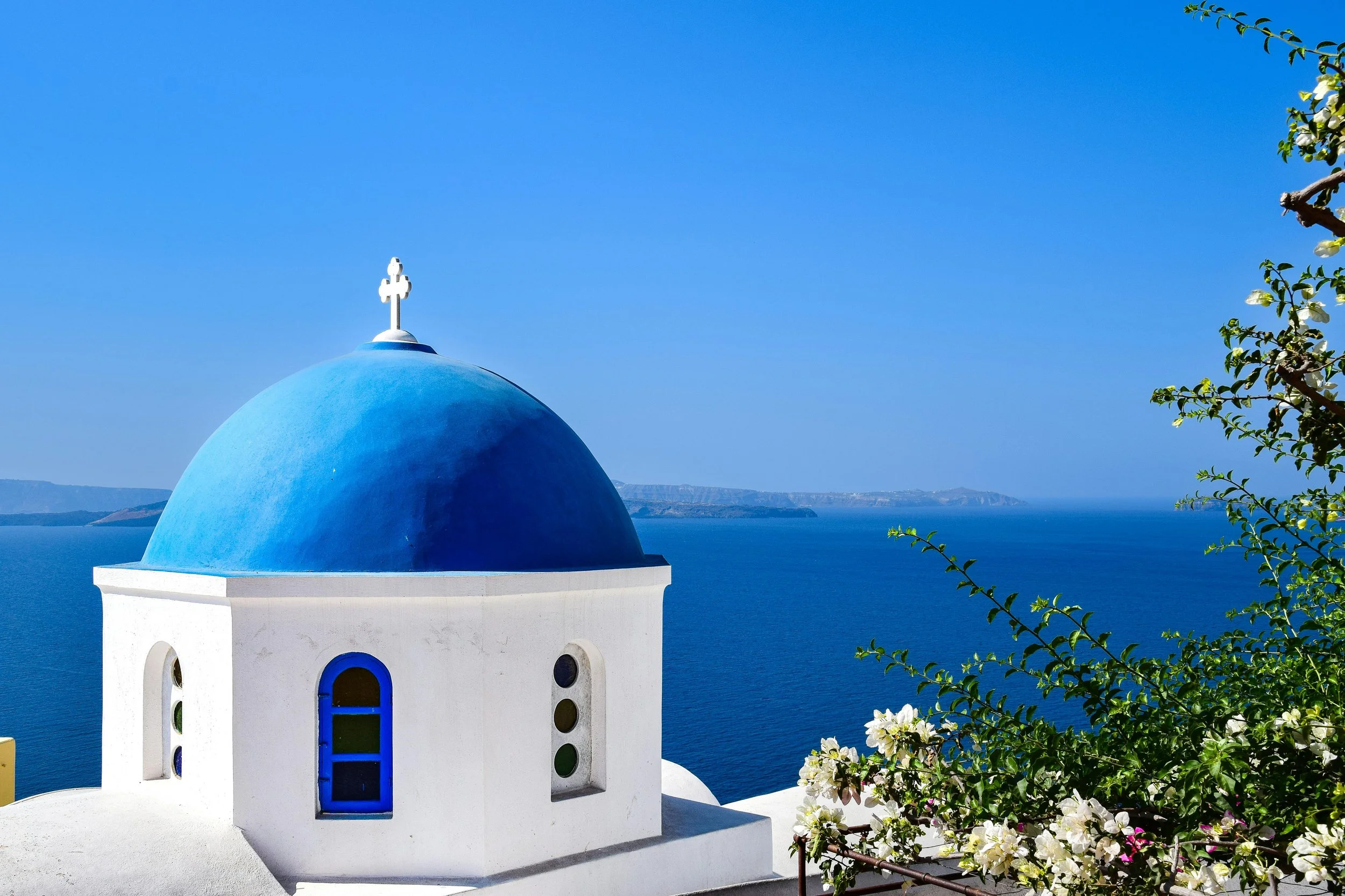 A photograph of a white building with a blue dome, taken in daylight.