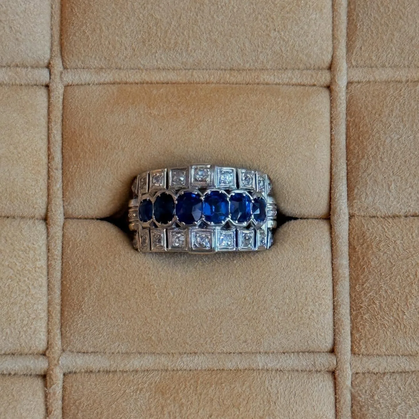 Wishing you a happy Monday and a beautiful week ahead with our ring &mdash; an Italian design from the 1950s crafted in 18-karat white gold, featuring a wide-band style adorned with deep blue natural sapphires in an oval row at the center, framed by 