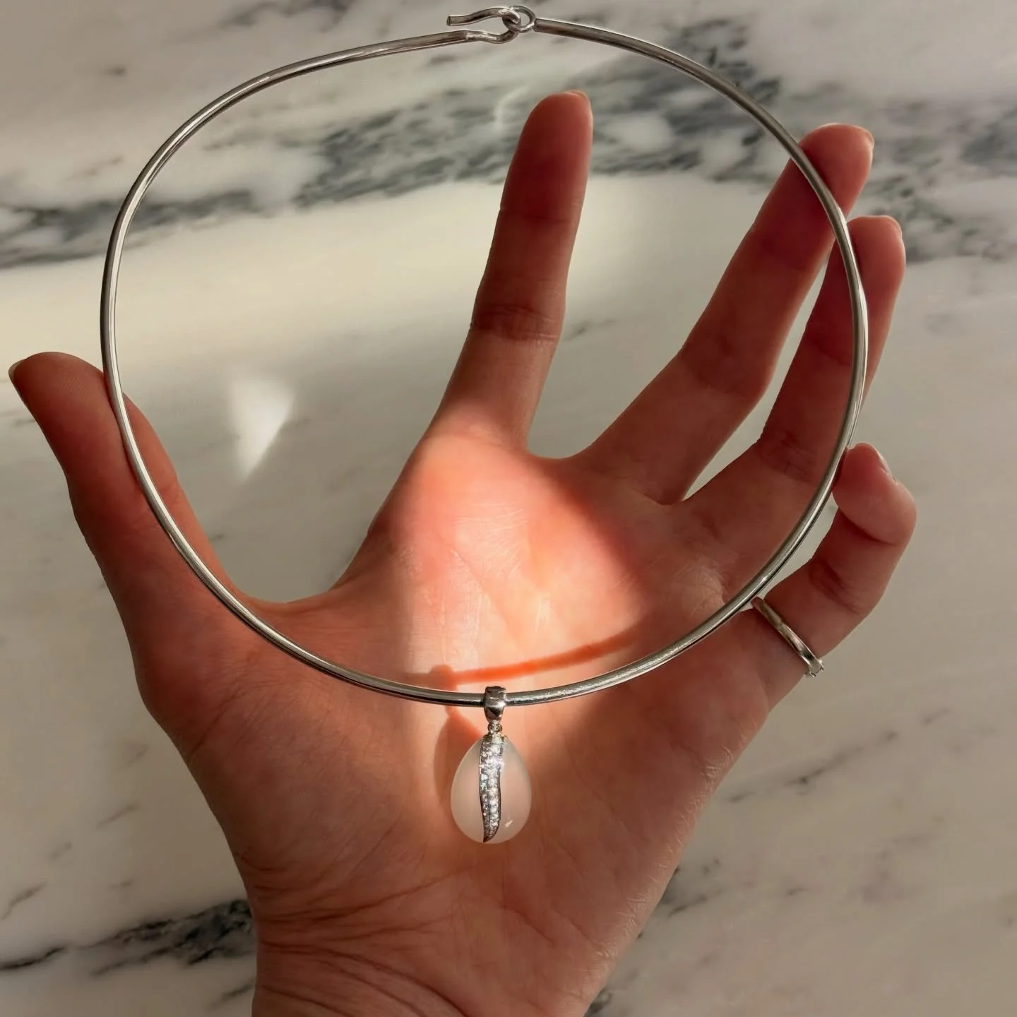 The light lives inside the stone and it only appears in motion.
18k white gold. A single moonstone, hand-carved, with diamonds set into the stone.
Live this weekend. 🤍
