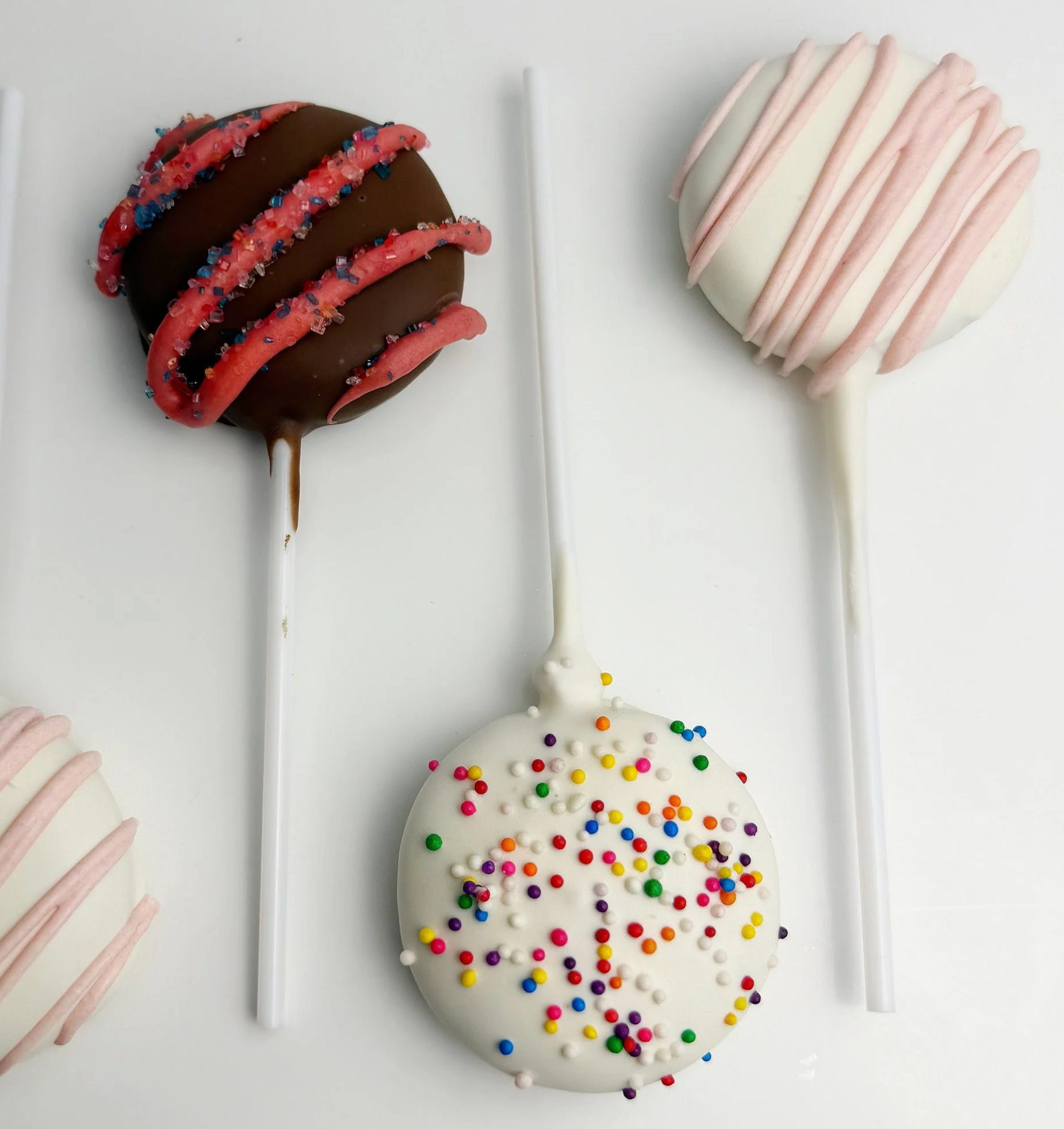 CAKE POPS -Our handmade cake pops are the perfect bite-sized indulgence! Each pop features moist, flavorful cake blended with frosting, dipped in a rich chocolate candy coating, and finished with colorful sprinkles or decor. Each pop is individually 