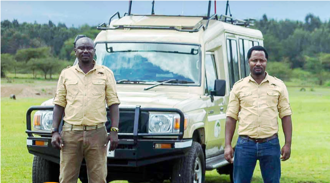 Safari guides in front of a truck