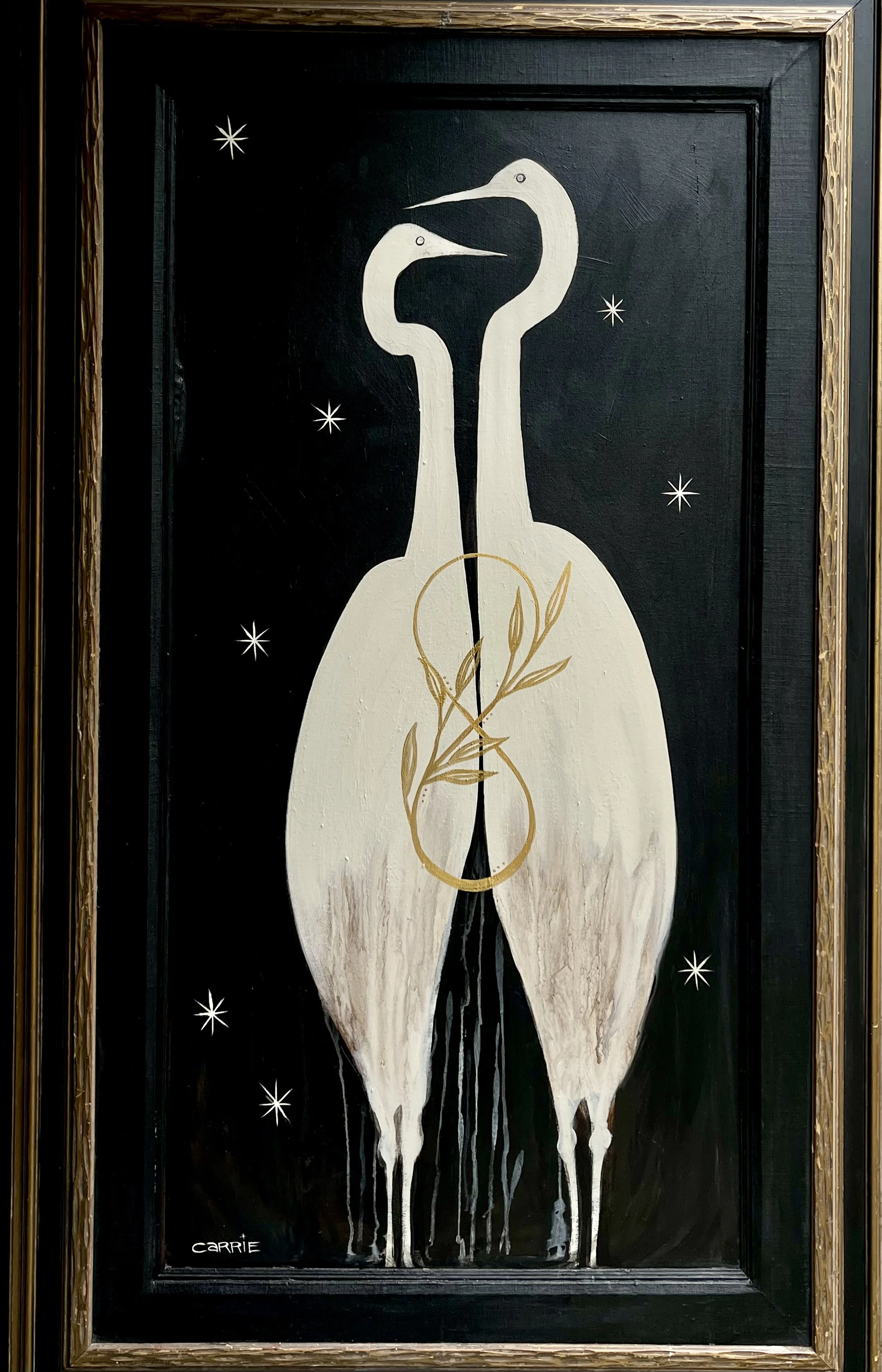 Painting of two white herons facing each other on a black background with star-like accents, enclosed in a wooden frame.