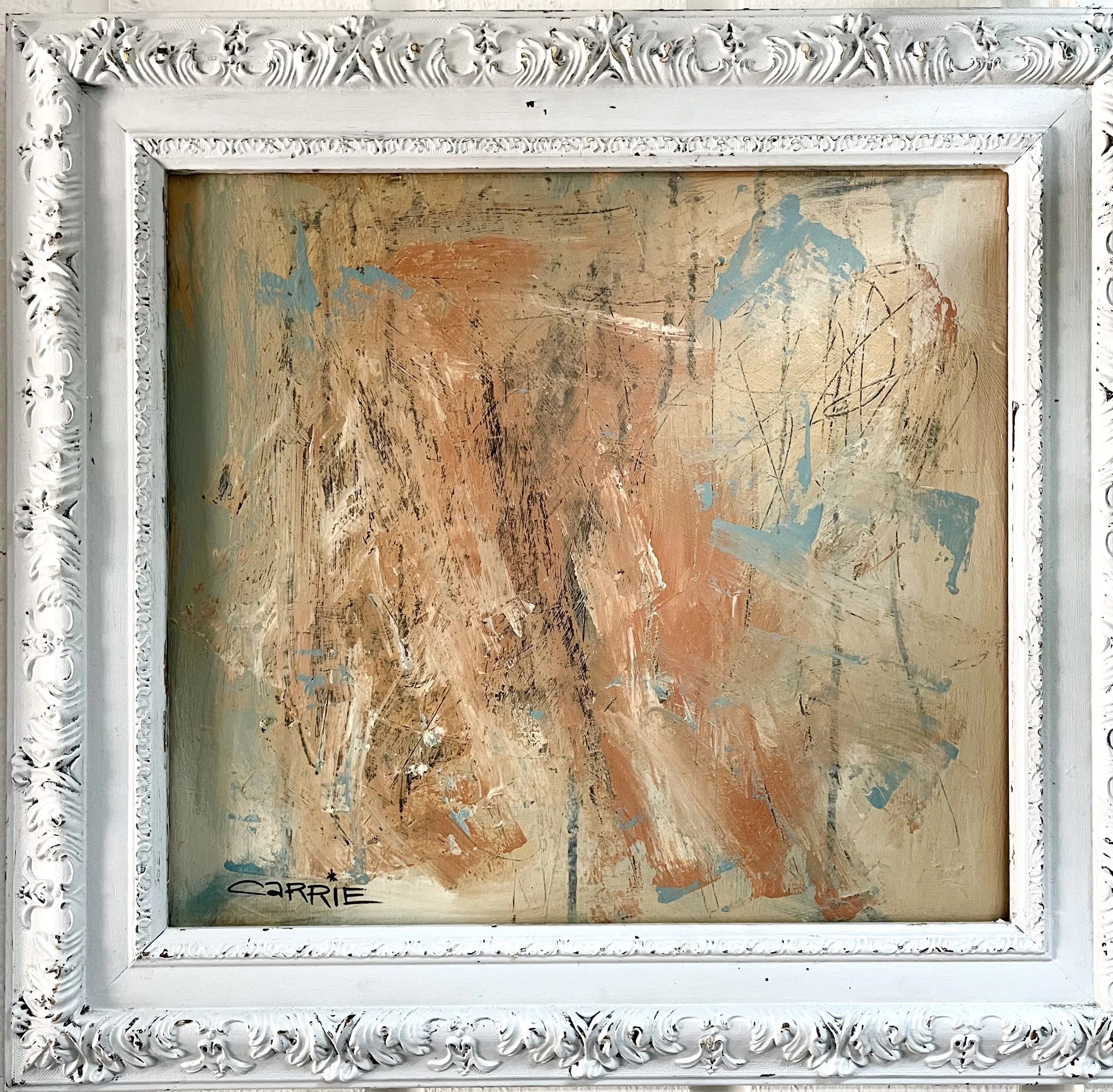 Abstract painting with textured brushstrokes in shades of orange, beige, blue, and black, framed by an ornate white frame with intricate patterns. The bottom left corner features the signature 'Carrie'.