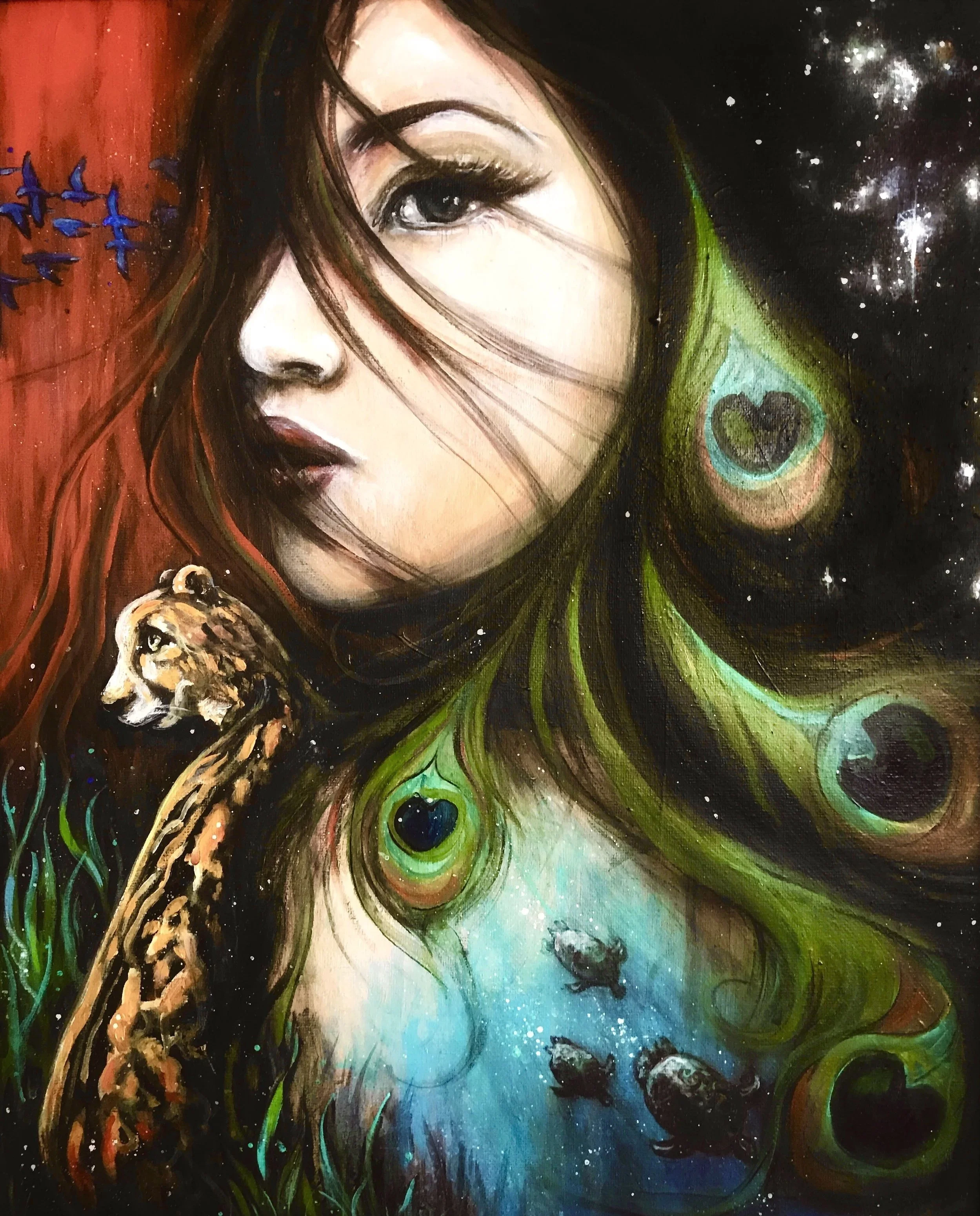 A colorful painting of a woman's face with flowing hair that transitions from red to black with green accents. The background features stars and cosmic elements, including peacock feather eye patterns and small fish swimming in the lower part. A lion