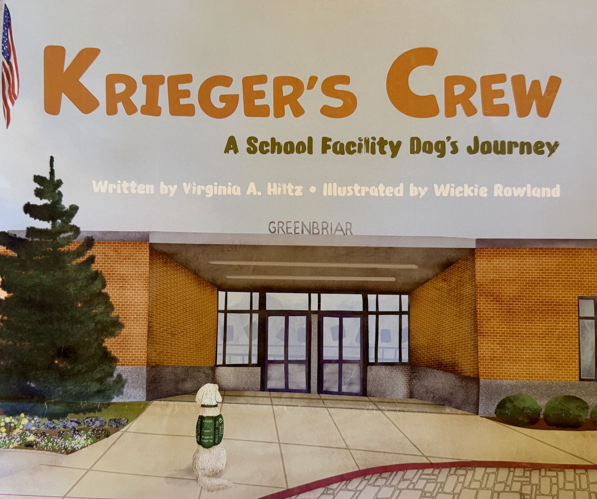 Book cover titled 'Krieger's Crew: A School Facility Dog's Journey' written by Virginia A. Hiltz and illustrated by Wickie Rowland, set in front of a school building with brick walls and a glass entrance, decorated with plants and sidewalk.