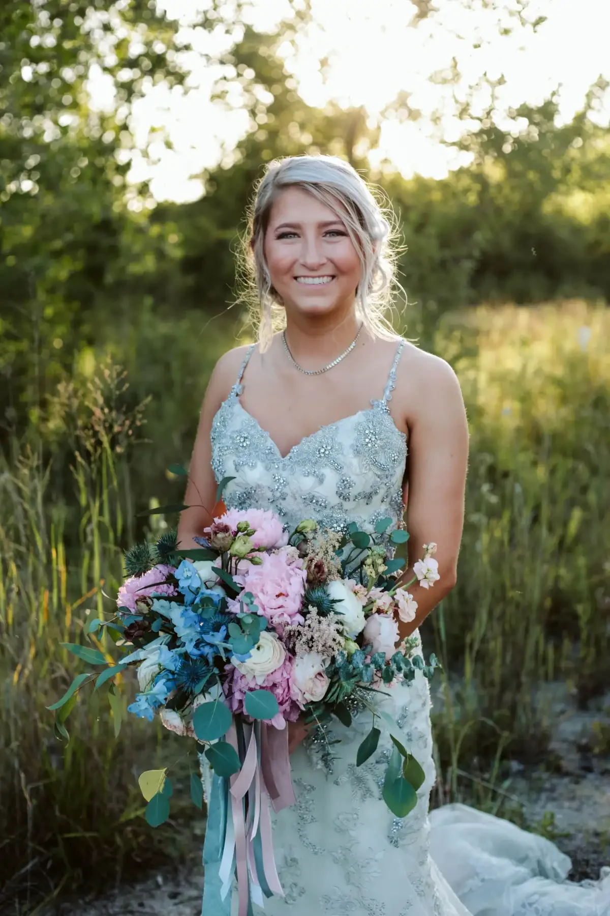 bridal-portrait-smiling-blue-sequin-dress-golden-hour-sycamore-tree.webp
