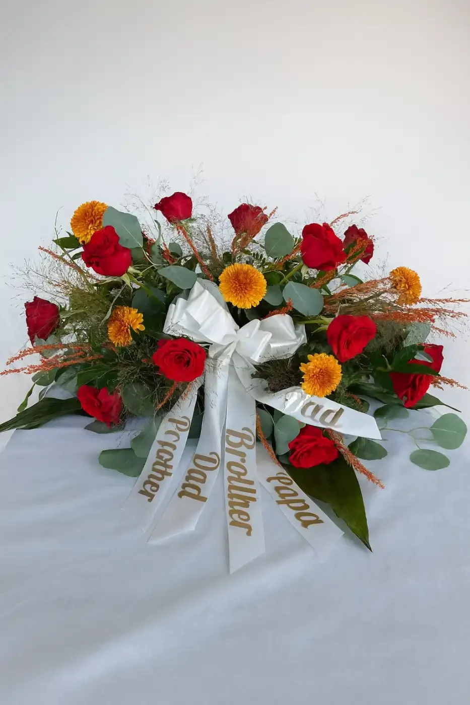 Warm-red-orange-fall-casket-spray-floral-stories.webp