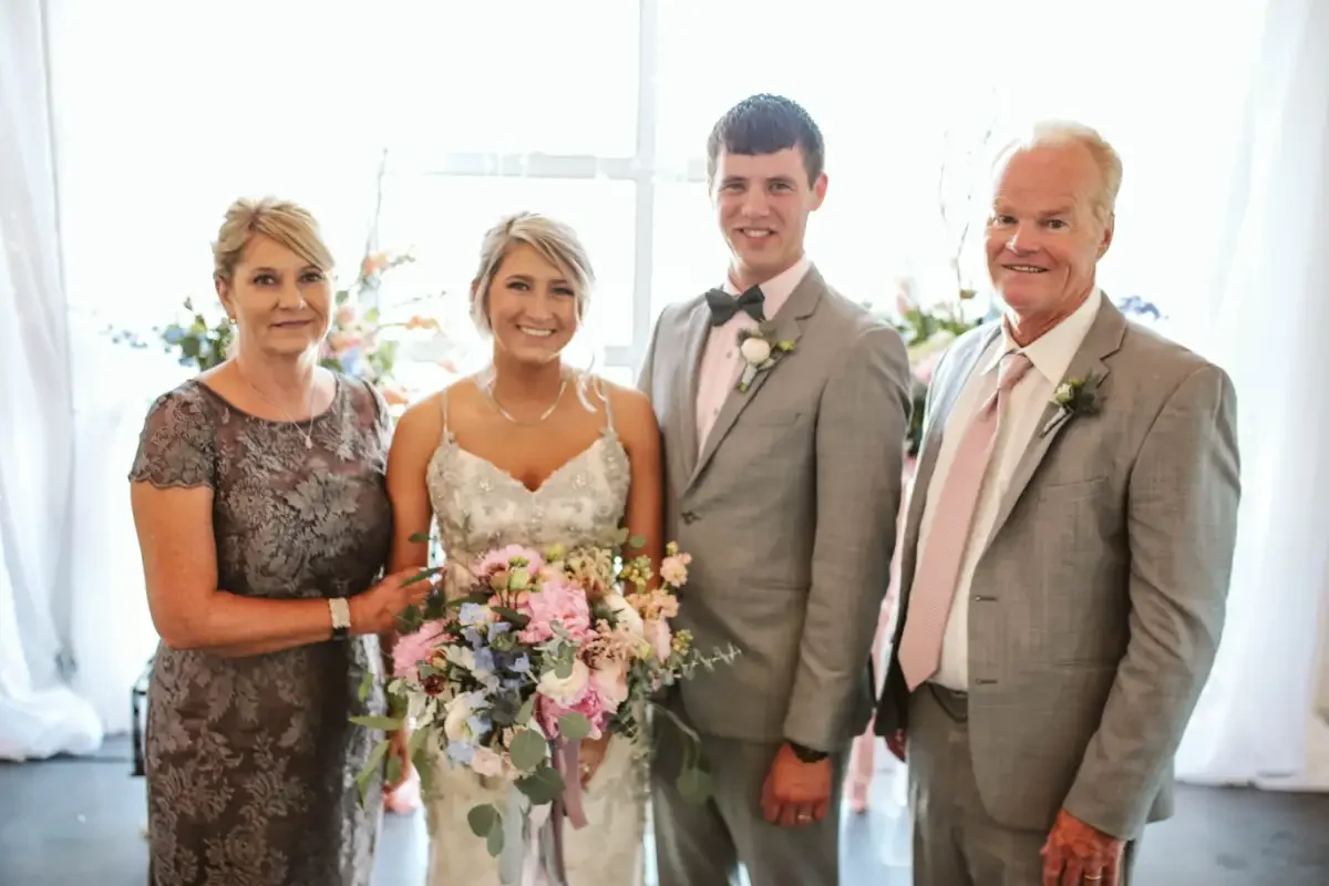 bride-with-parents-wedding-portrait-sycamore-tree-savannah-mo.webp