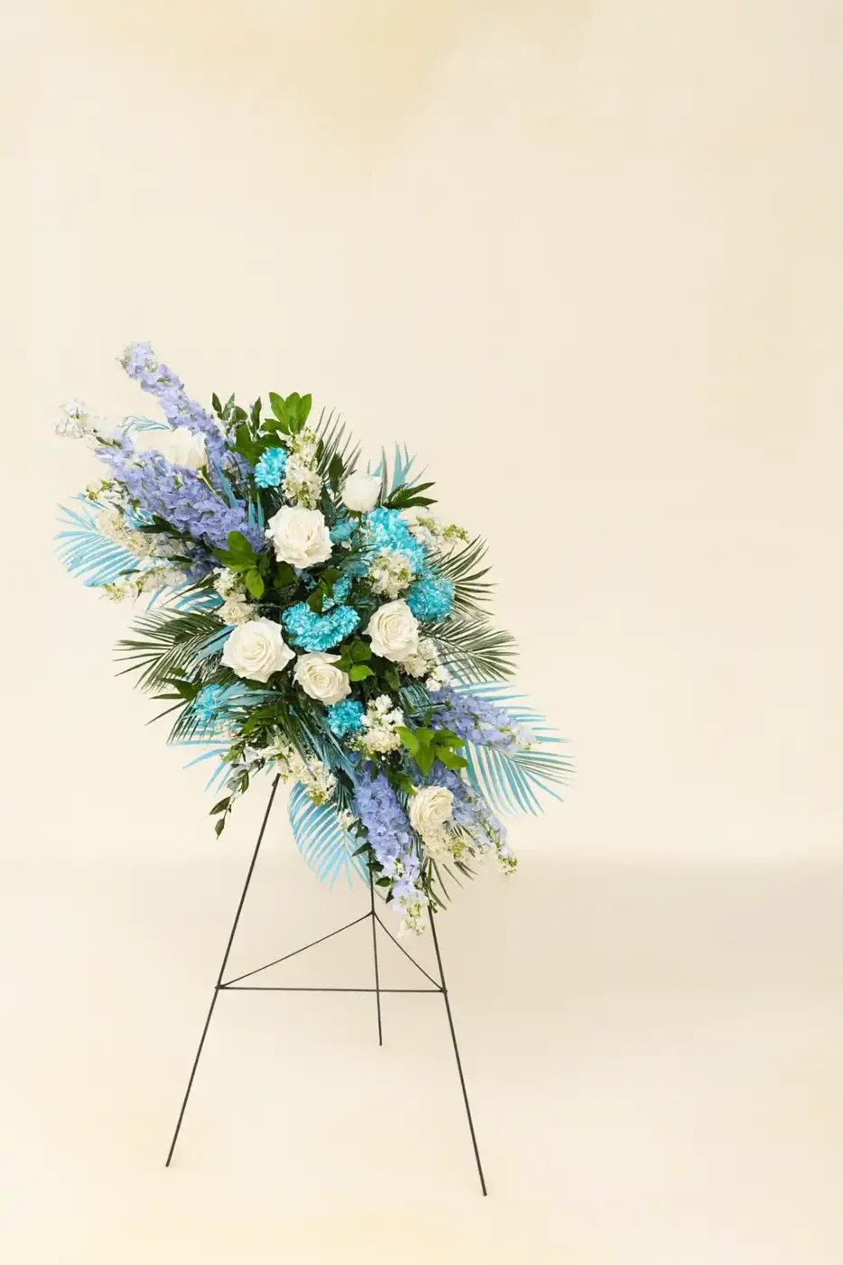 soft-blue-white-sympathy-standing-spray-floral-stories.webp