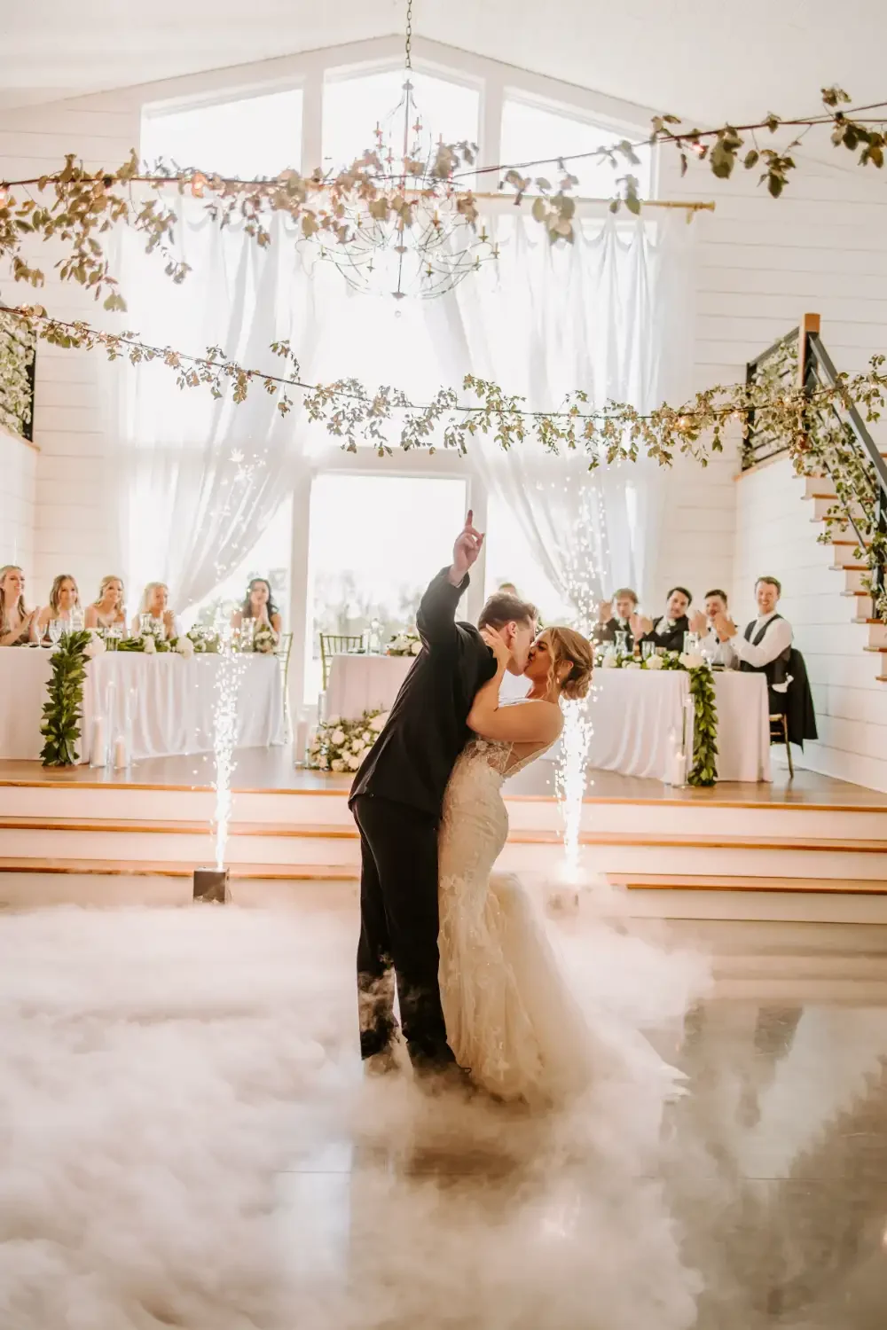 first-dance-sparklers-white-drapes-emerson-fields-floral-stories.webp