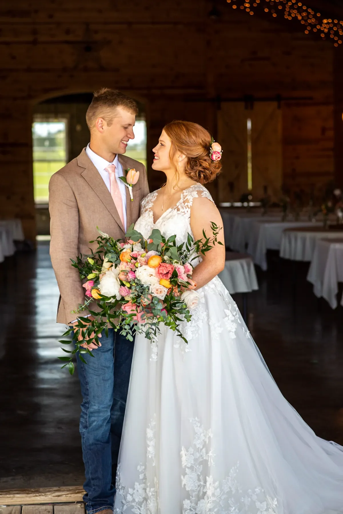 bride-holding-bouquet-lace-gown-floral-closeup-floralstories.webp