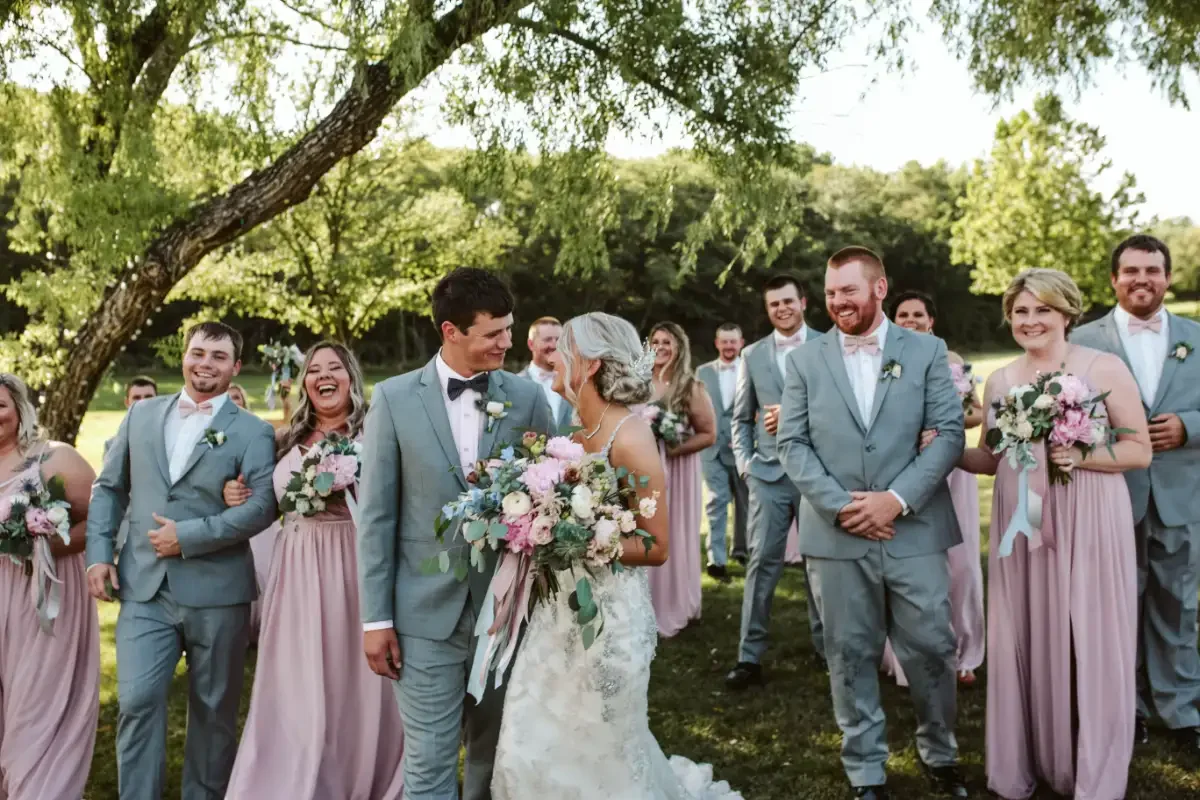 bride-groom-walking-laughing-with-wedding-party-sycamore-tree-floralstories.webp