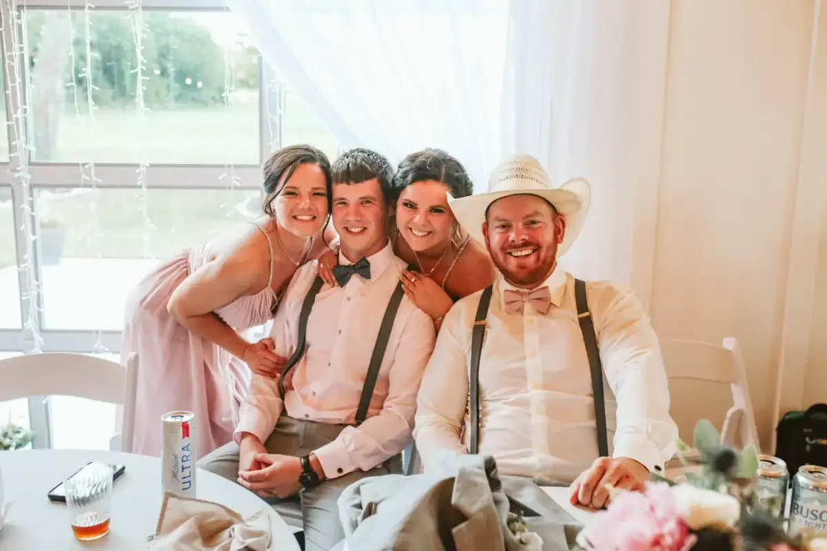 wedding-reception-fun-bridal-party-photo-bowties-suspenders-sycamore-tree.webp