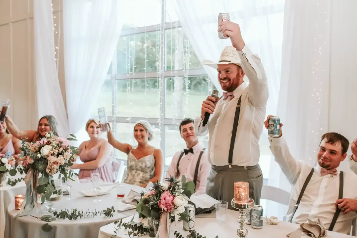 wedding-toast-moment-head-table-pink-dresses-sycamore-tree-floralstories.webp