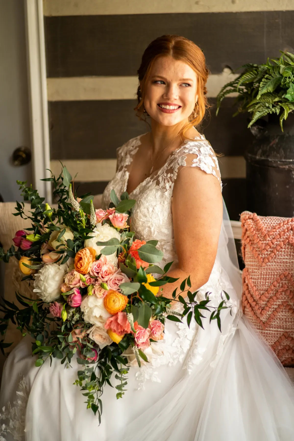 bride-smiling-portrait-orange-white-bouquet-floralstories.webp