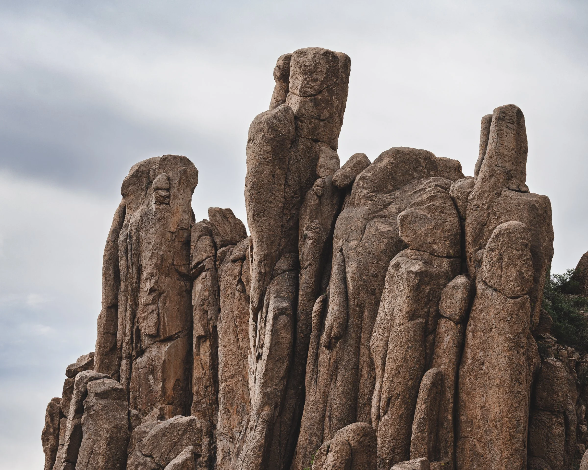 Superstition Wilderness, Arizona, Tall rugged rock formations against a cloudy sky.