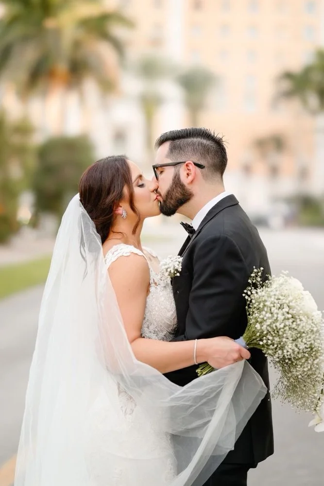 Bride and groom kissing outdoors on their wedding day