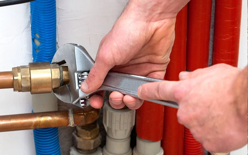 Plumber performing water valve repair in Edmond Oklahoma