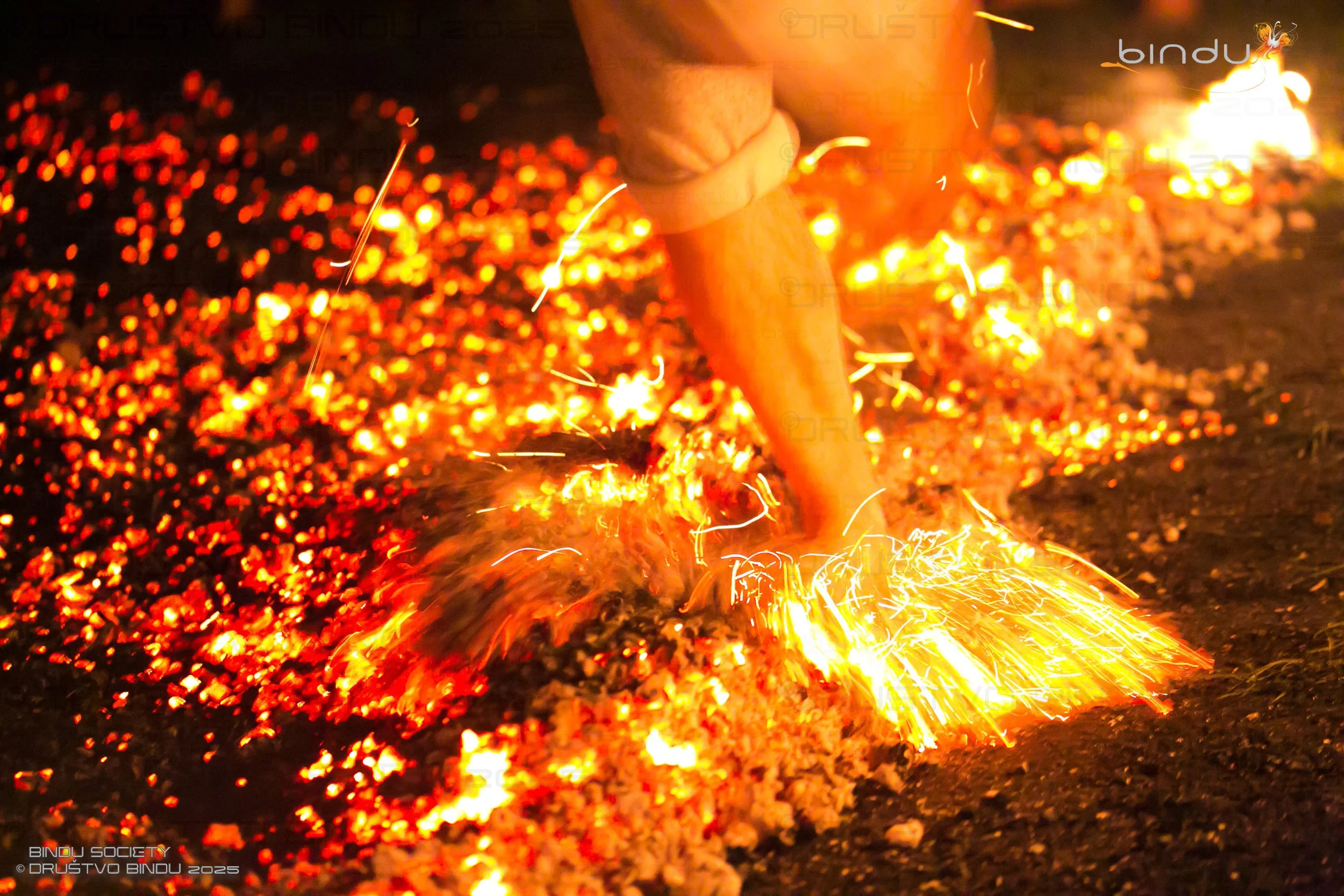 Close-up of a person using a grinder to cut or grind metal, with sparks flying around in a workshop or industrial setting.