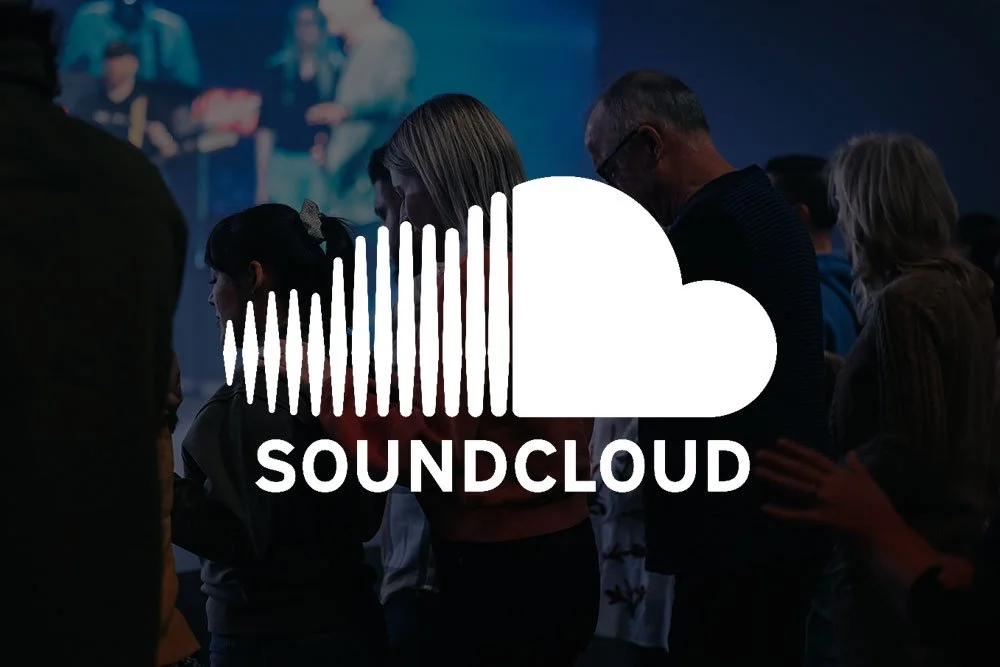 People praying in a darkened room with the SoundCloud logo superimposed.