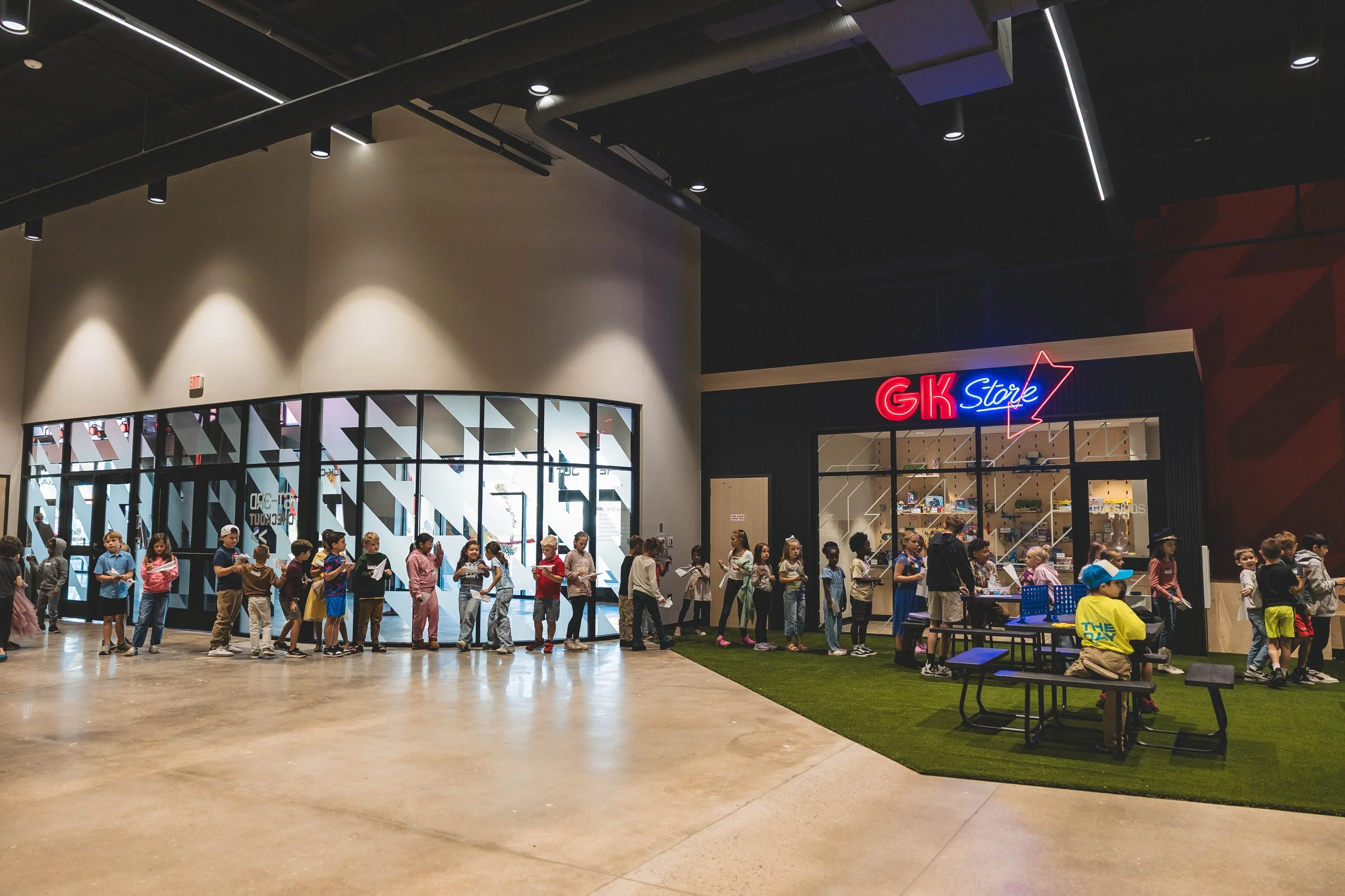 Line of children waiting outside a retail store in a shopping mall.