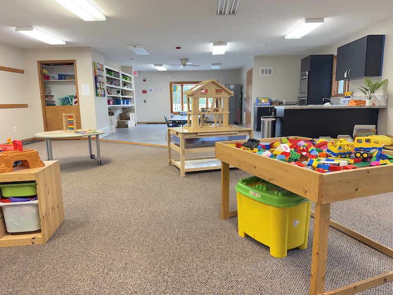 Kid Star Daycare Center classroom with activity tables and building blocks—kids learning through age-appropriate play in Paw Paw, Michigan.