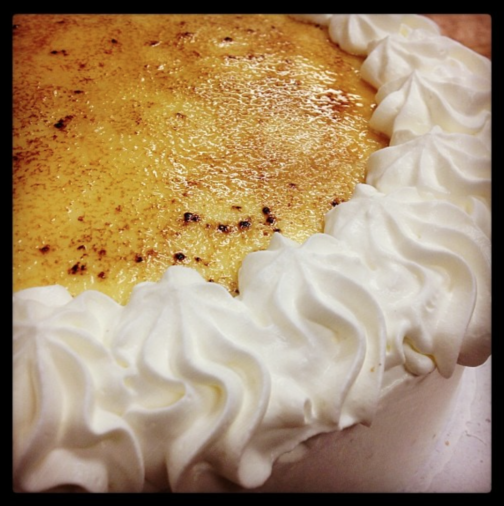 Gluten Free Yellow Cake with Crème Brulee, Raspberry Filling, and Whipped Cream Frosting.