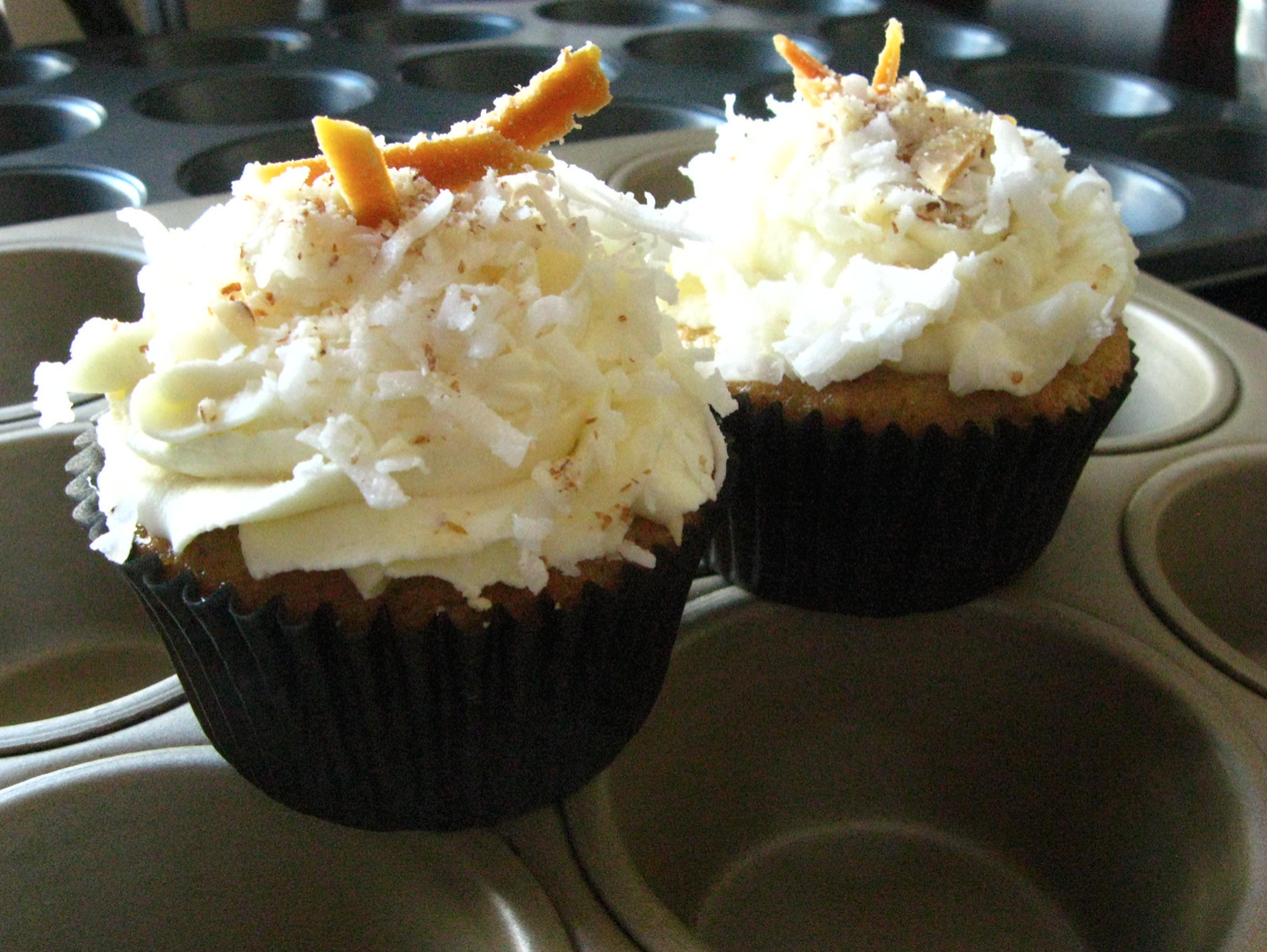 Tropical Vacation Cupcakes-- Mango Peach Almond Cupcakes with Mascarpone Whipped Cream, Coconut, and Dried Mango.