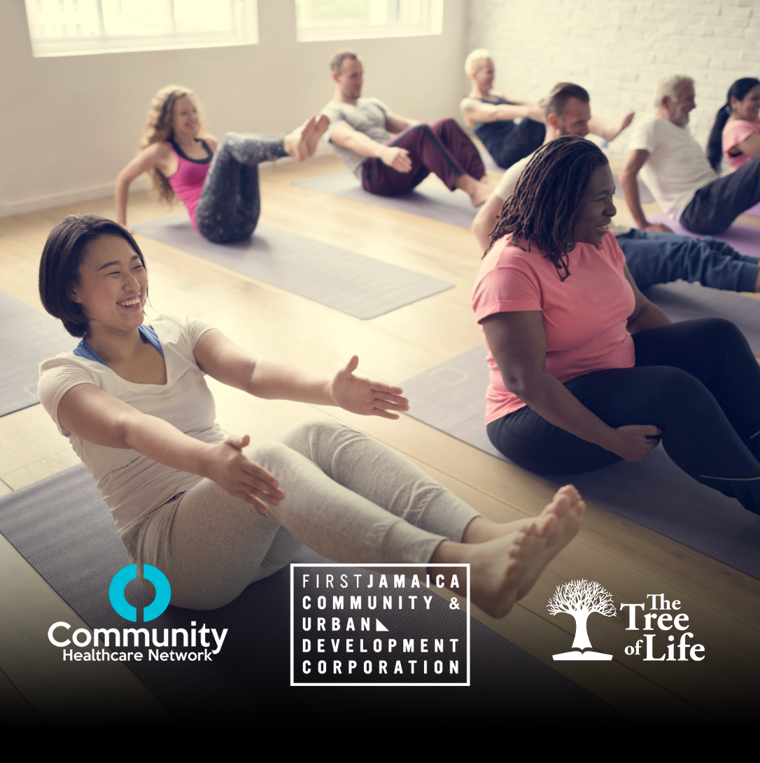 Group of diverse people practicing yoga or meditation on mats in a bright room with large windows.