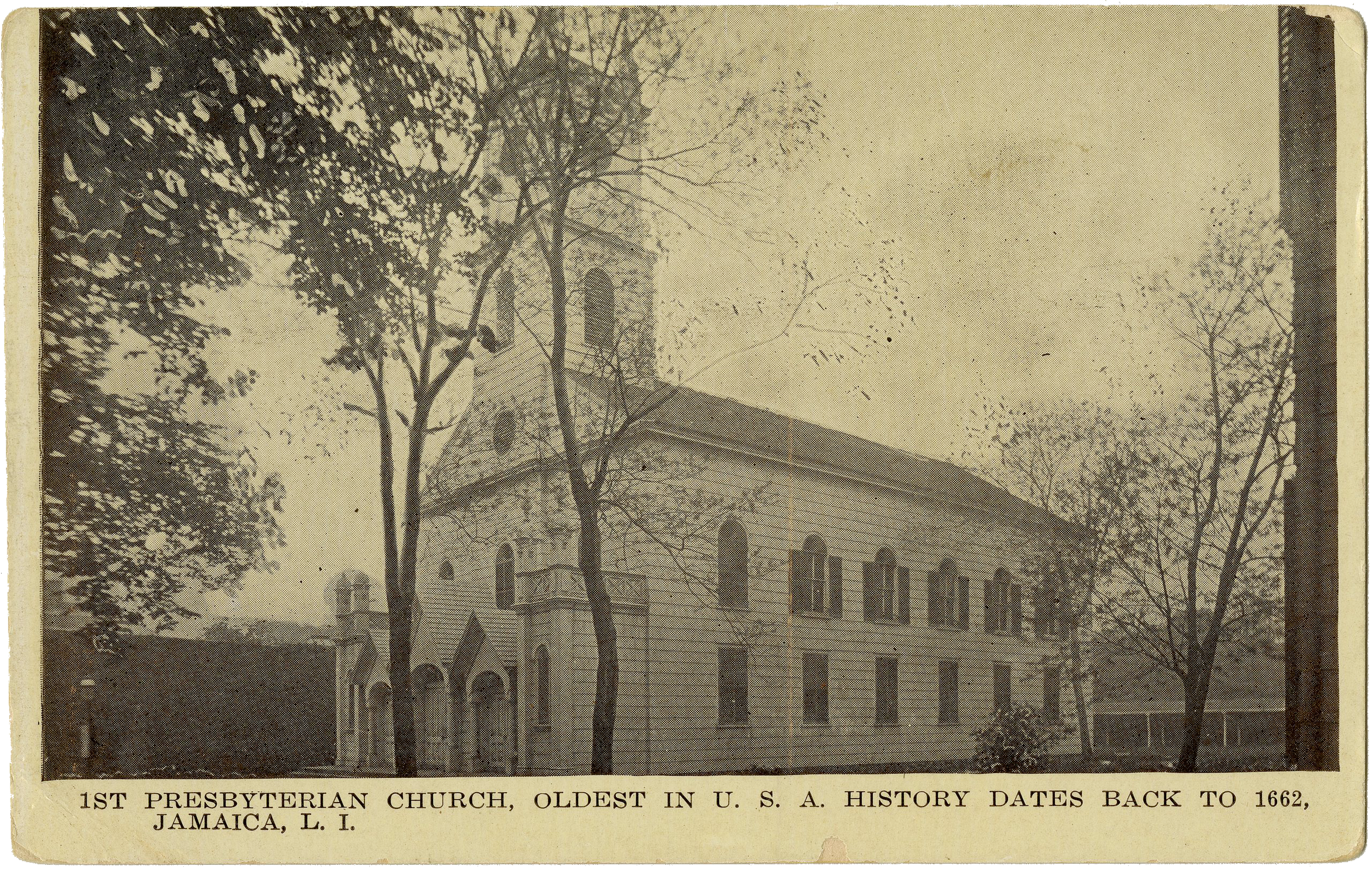 A historic black and white photograph of the 1st Presbyterian Church in Jamaica, Long Island, the oldest in U.S. history, dating back to 1662. The church is surrounded by leafless trees and features a tall steeple and arched windows.