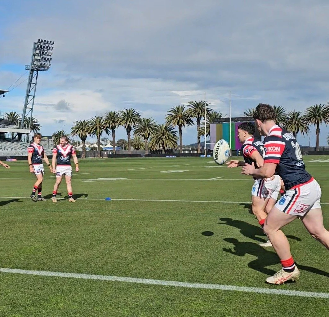 Mitch coaching a rugby league team through a field-based training drill.