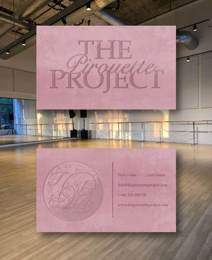 Business card for The Pirouette Project, featuring a pink background, embossed logo, phone number, email, and website, in an indoor dance studio with a wooden floor and large screen displaying the business name.