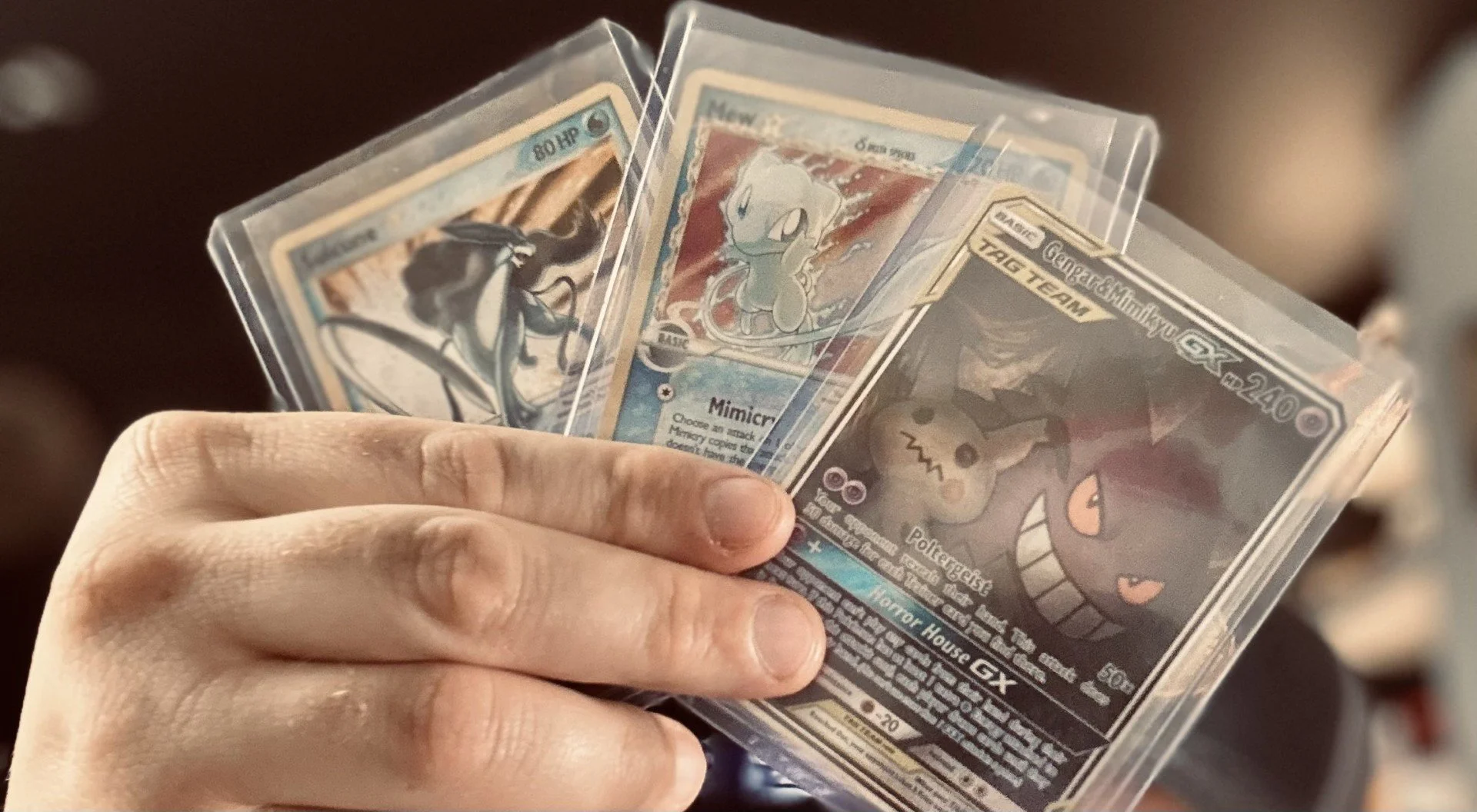 Pokémon trading cards, including Gengar-GX and Pikachu.