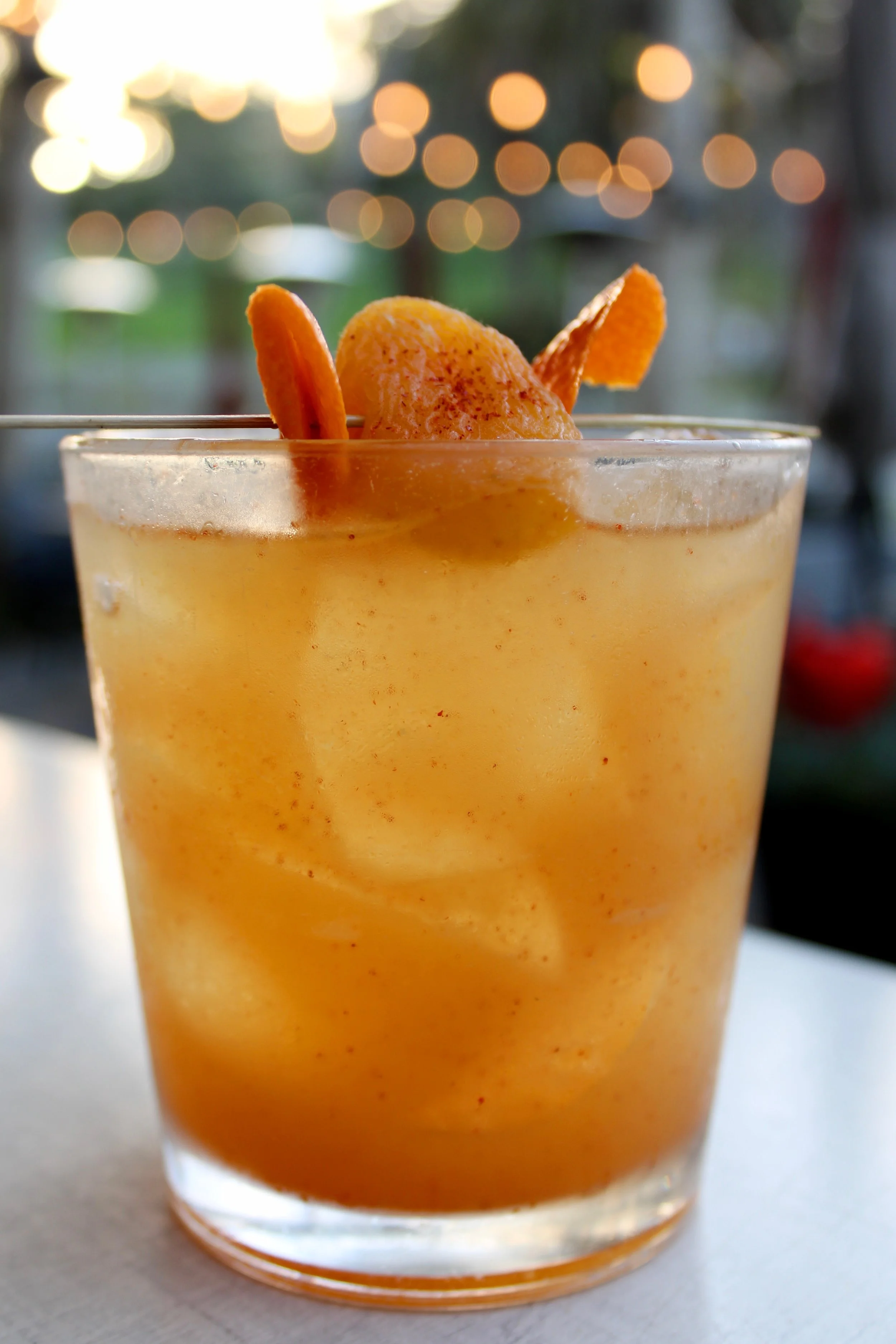 Southern Glow: This cocktail layers smooth bourbon with the lush sweetness of apricot, brightened by fresh lemon and finished with a hint of cayenne heat. A twist of orange zest ties it altogether.