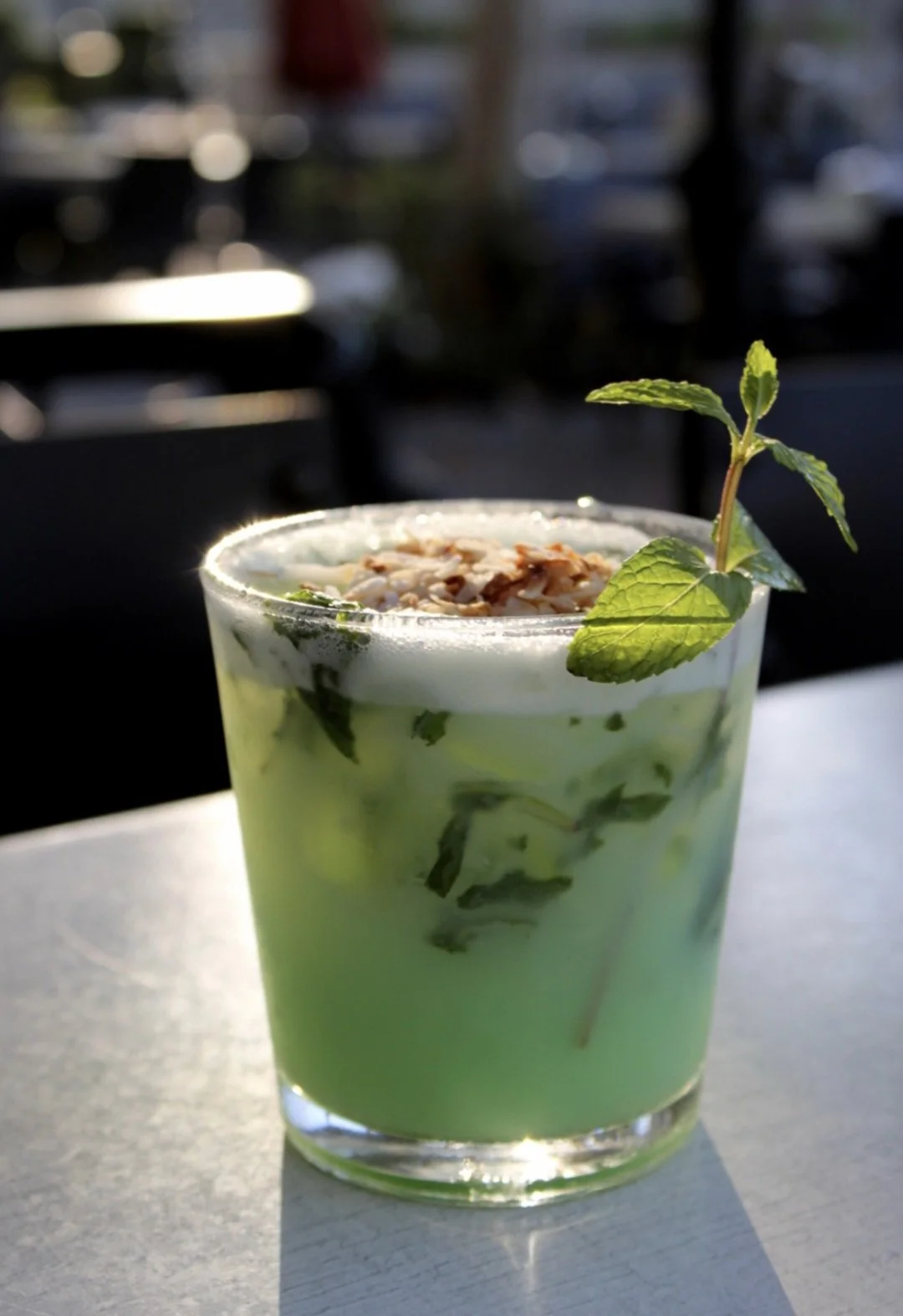 Mint Condition: This tropical beauty layers smooth vodka, with the fragrant sweetness of pandan, creamy coconut, and a burst of fresh mint and lime, topped with toasted coconut flakes.