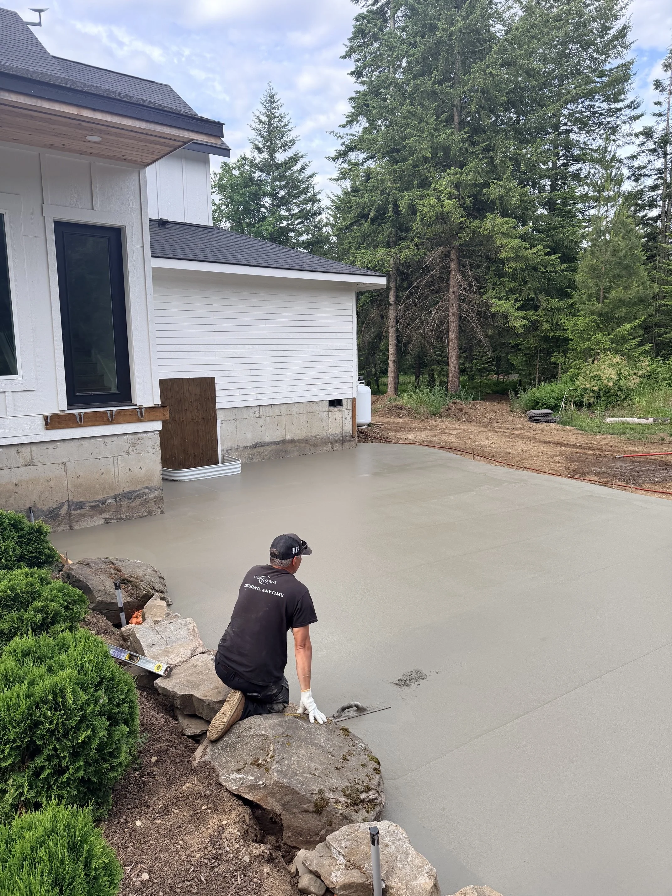 Concierge Inc inspecting the concrete patio they poured for clients in North idaho