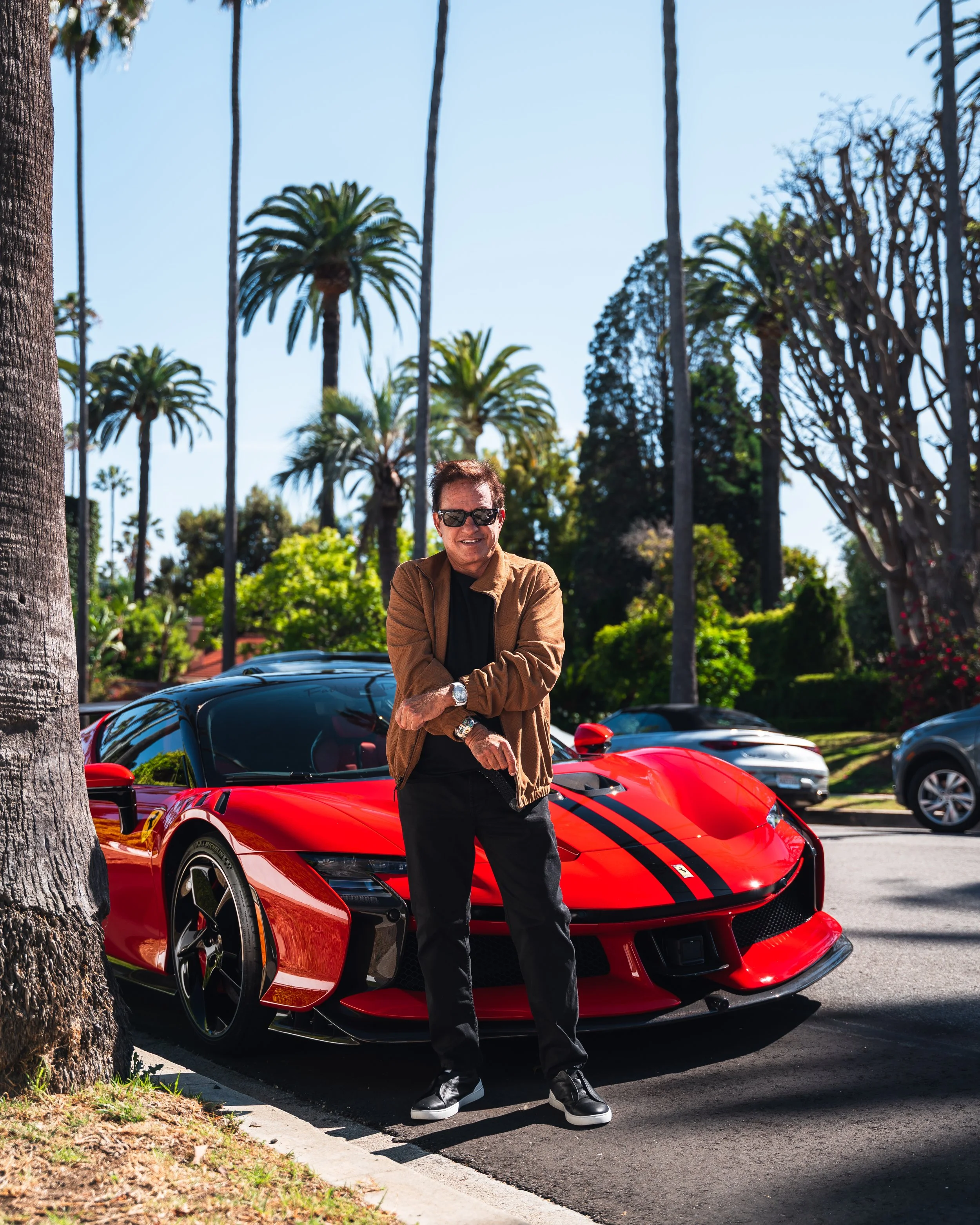 Marc Menowitz standing next to a red Ferrari SF90 XX