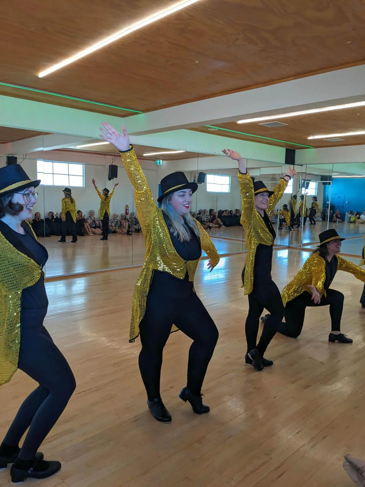 Dancers wearing gold sequin costumes