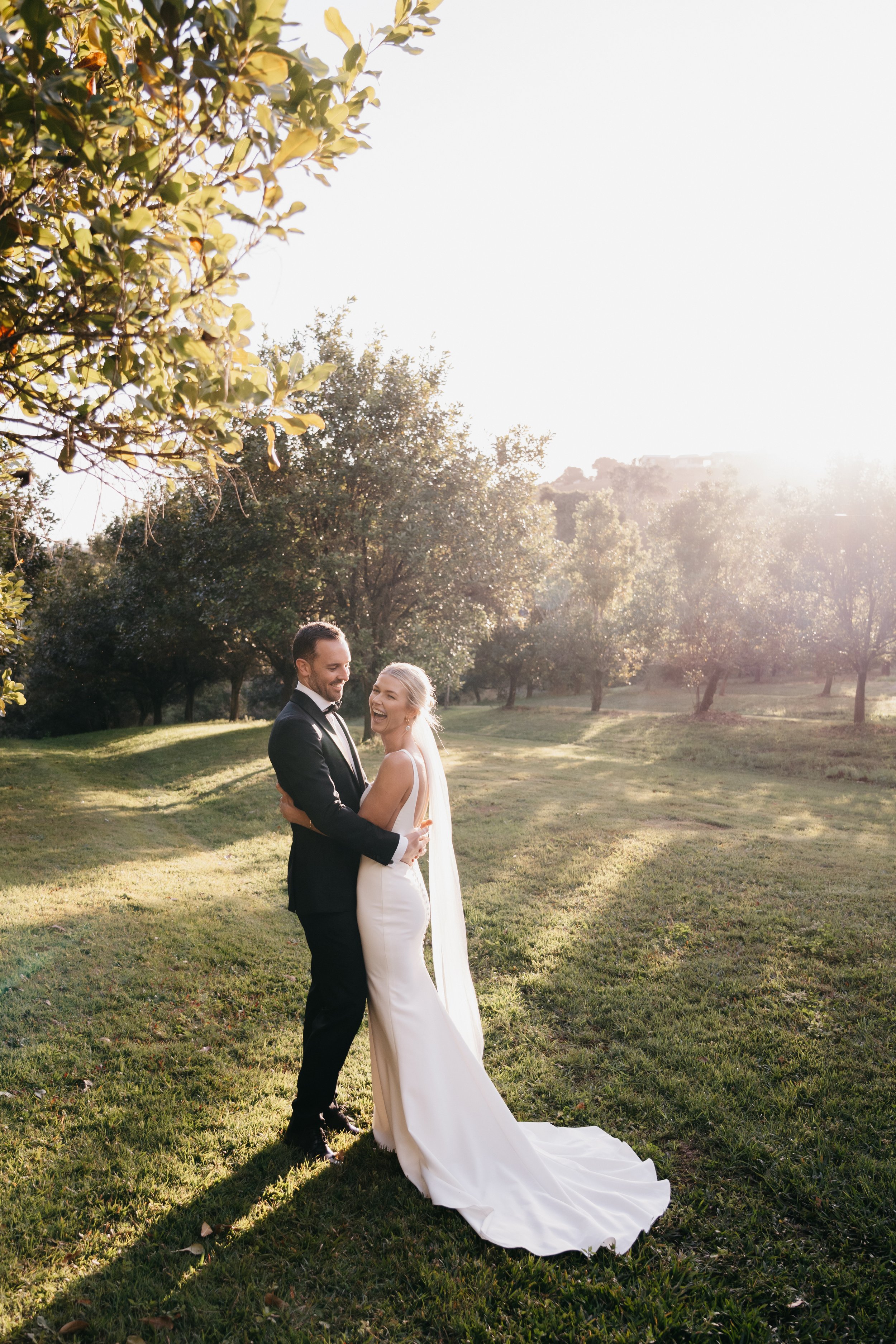 Laurie’s customers, Fernando and Kate embracing by the lake on their wedding day.