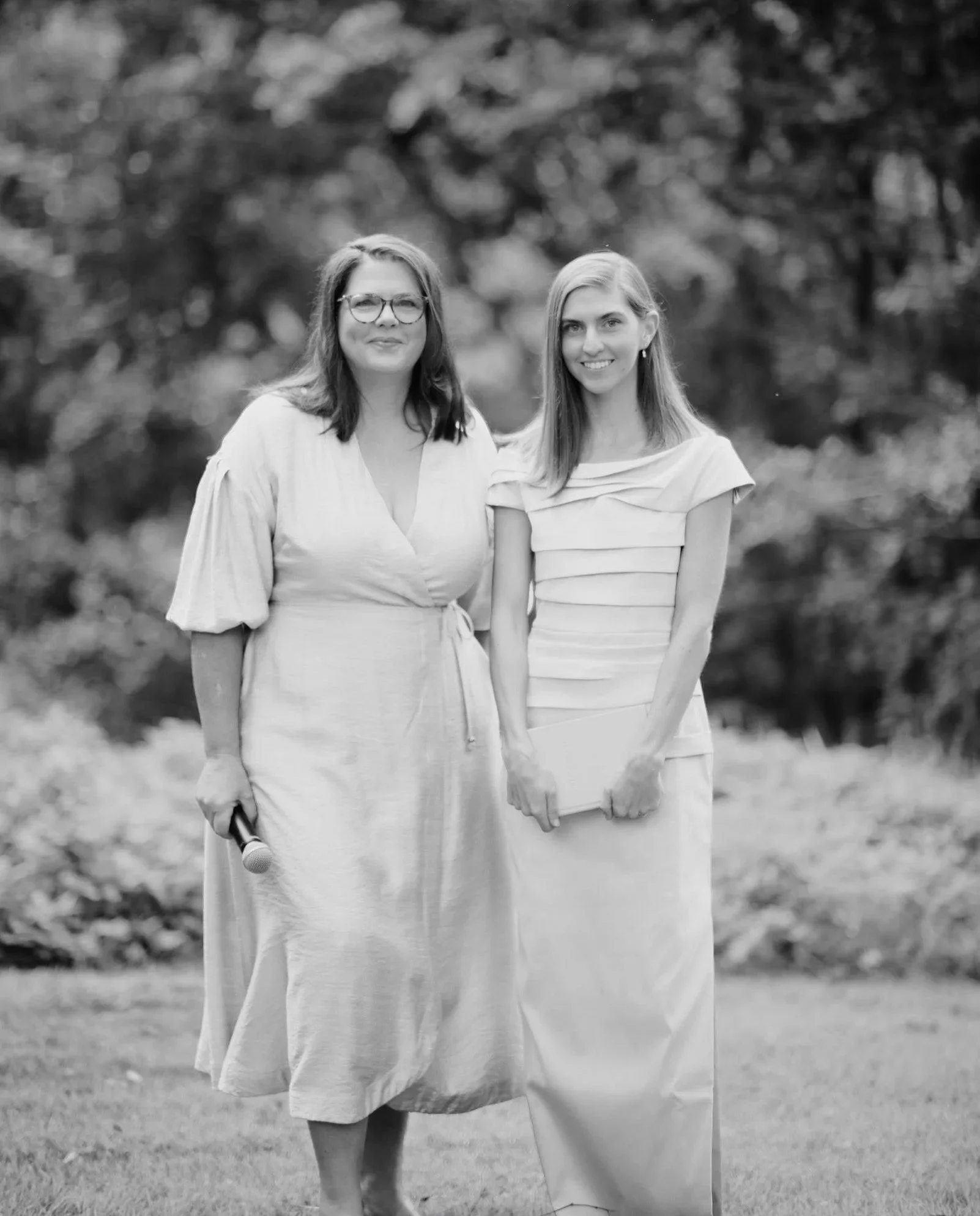 Two marriage celebrants, Brisbane-based, smiling as they deliver a wedding ceremony