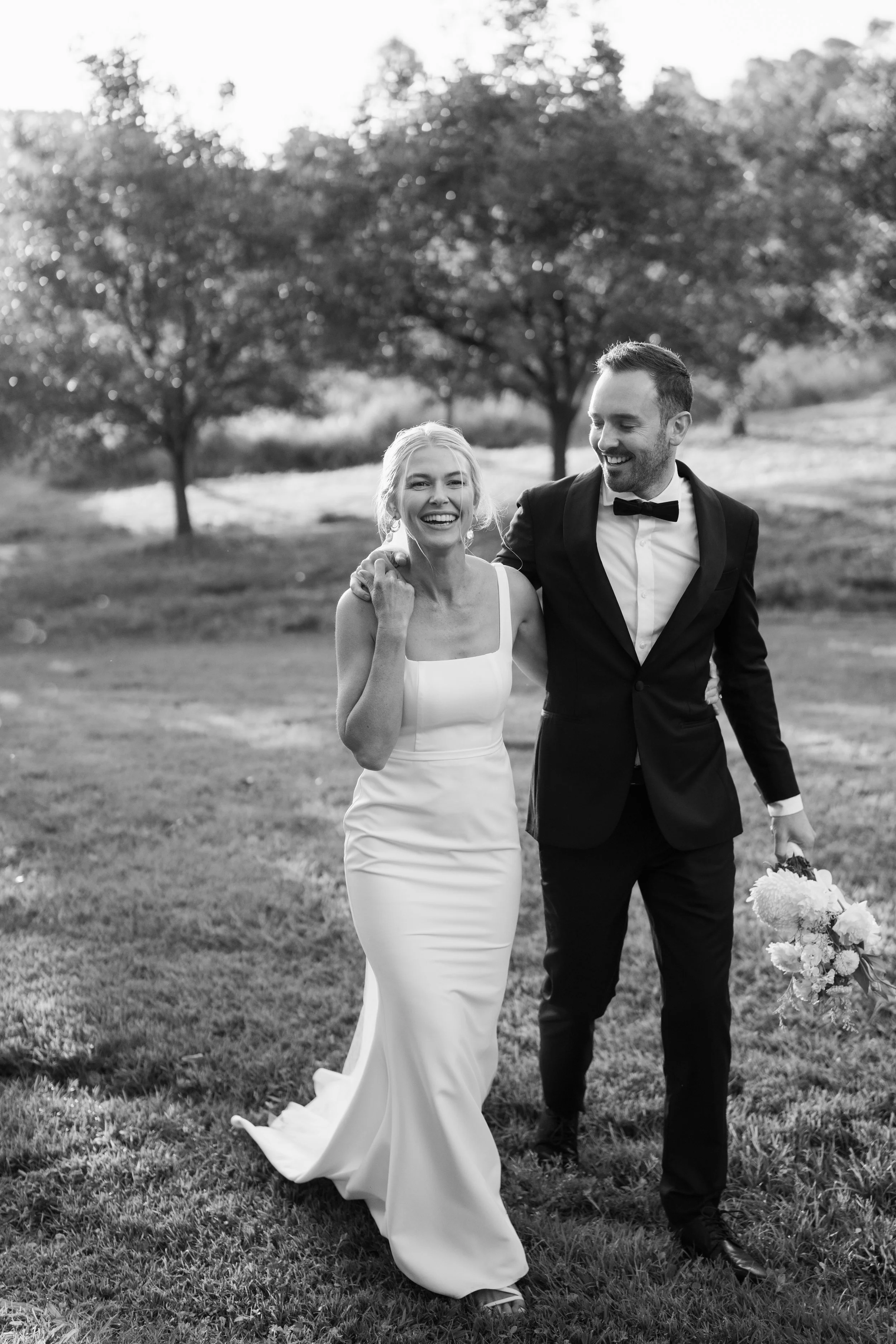 A bride and groom getting professional photography after their wedding ceremony with their photographer.