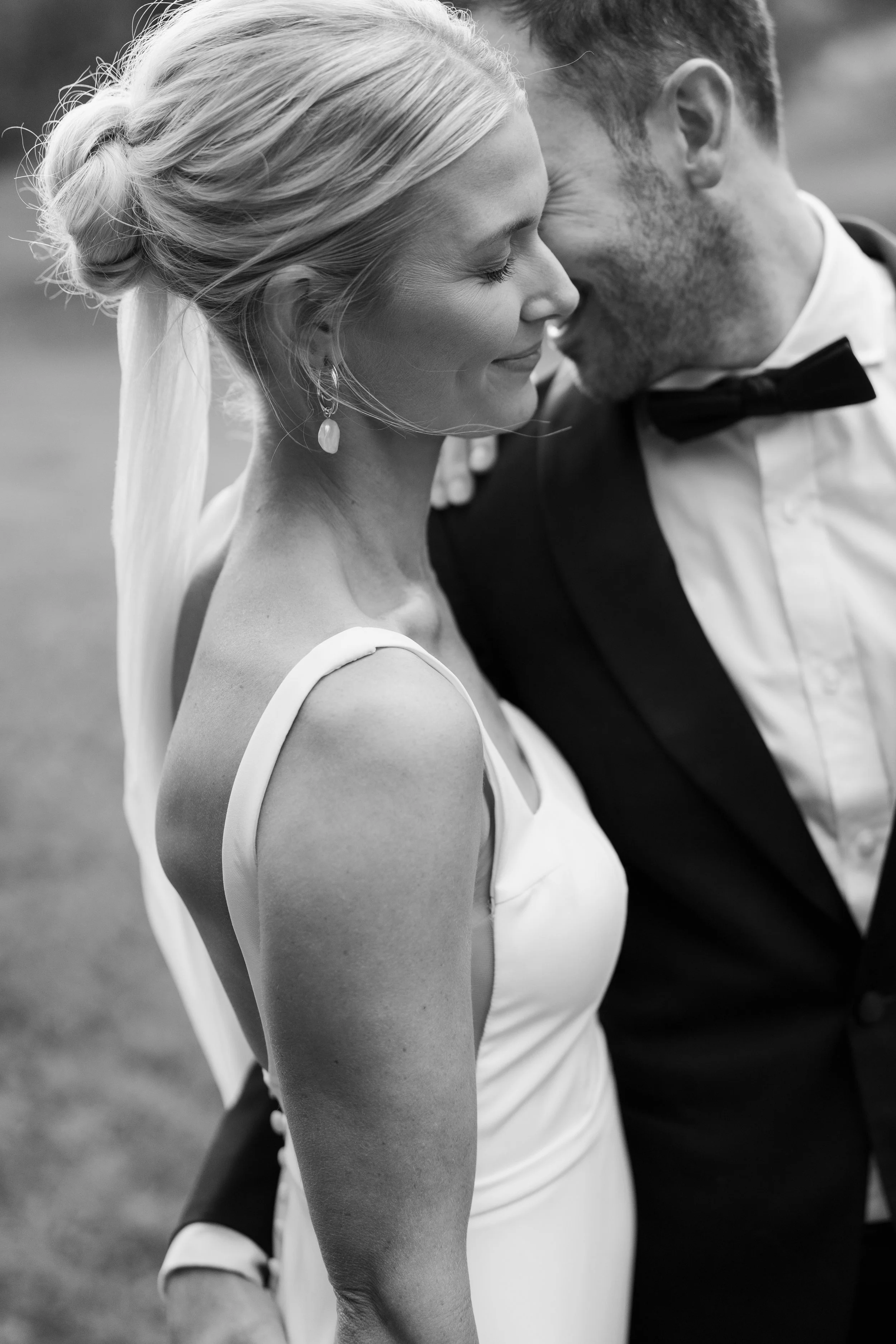 A black and white photo of a bride and groom during their wedding ceremony with their marriage celebrant.