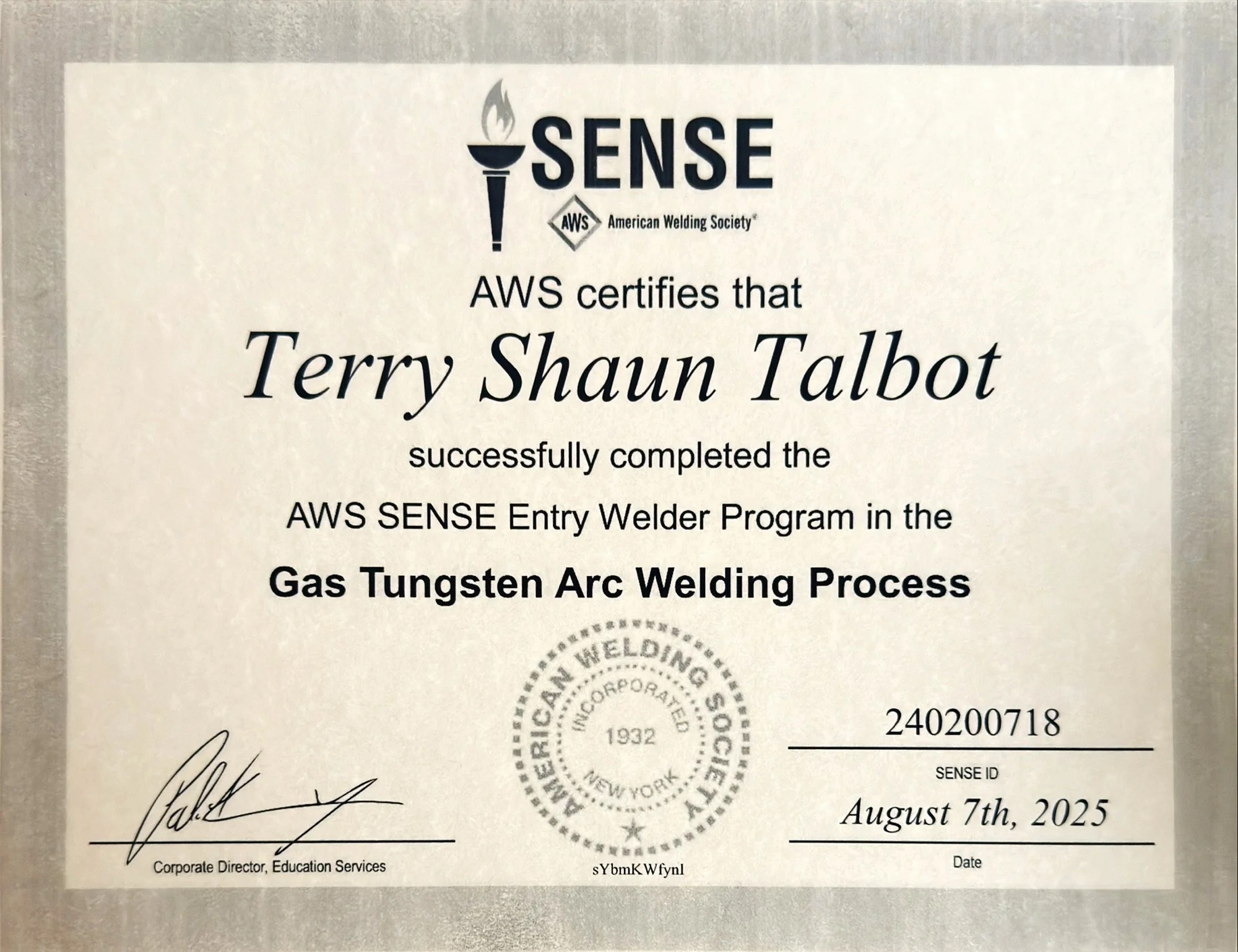 Certificate of completion from the American Welding Society awarded to Terry Shaun Talbot for completing the AWS SENSE Entry Welder Program in the Gas Tungsten Arc Welding Process, signed by the Corporate Director of Education Services, dated August 7, 2025.