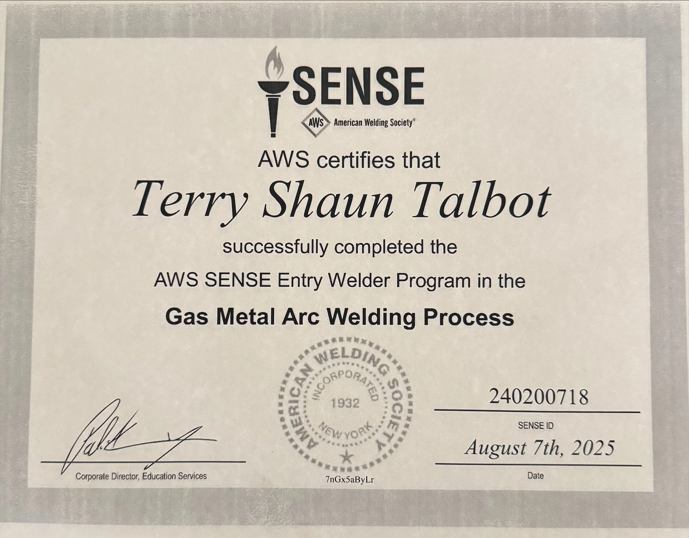 A certificate from the American Welding Society certifying that Terry Shaun Talbot has successfully completed the AWS SENSE Entry Welder Program in Gas Metal Arc Welding Process, dated August 7th, 2025.